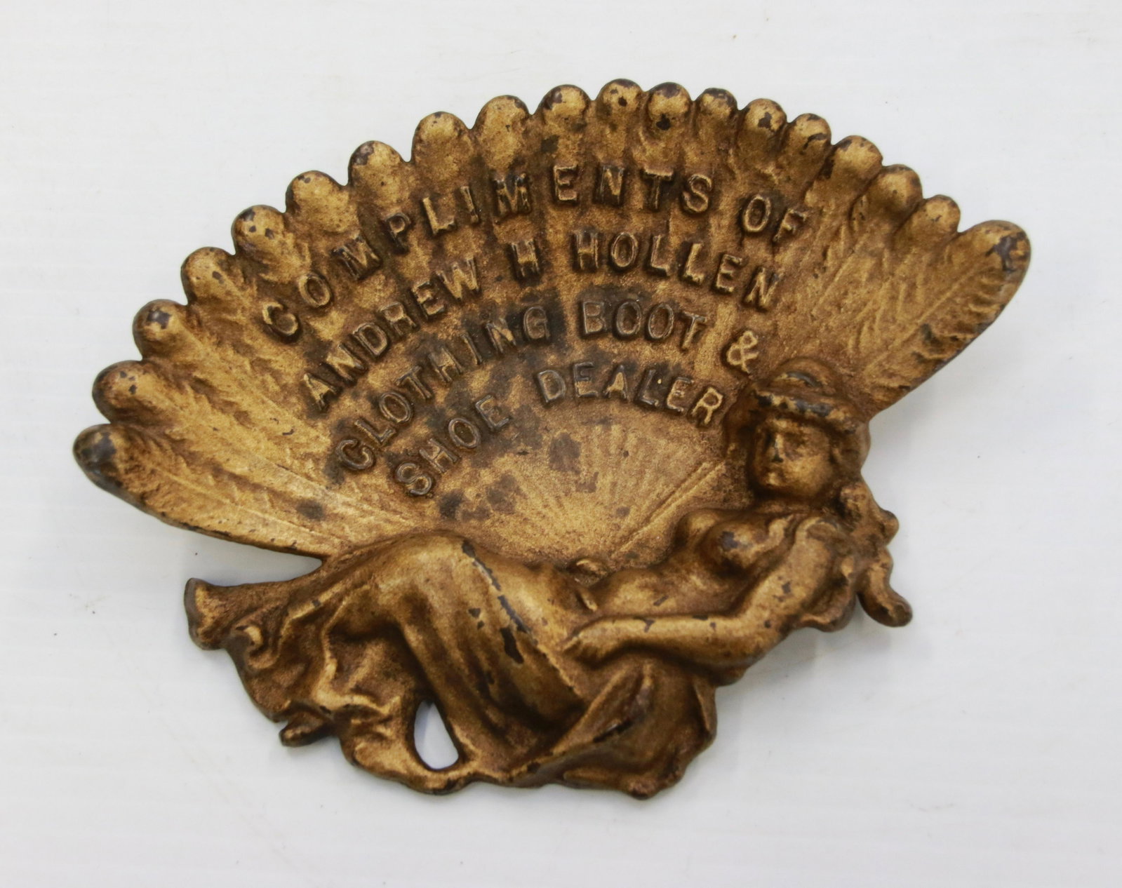 ADVERTISING PIN HOLDER: COMPLIMENTS OF ANDREW H. HOLLEN CLOTHING BOOT AND SHOE DEALER - CAST IRON PAINTED GOLD Size: 7" X 5"
