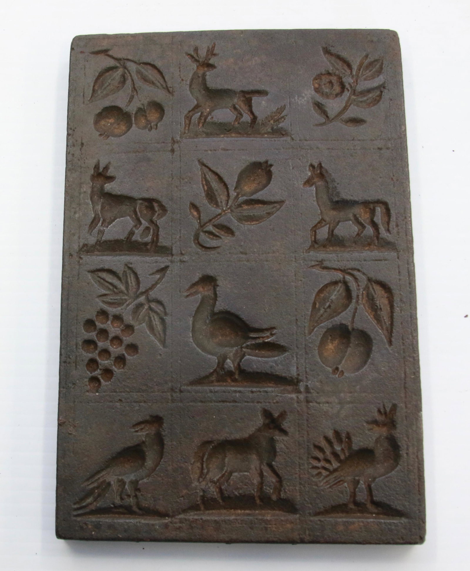 CAST IRON COOKIE MOLD: 19TH CENTURY MOLD WITH 12 IMAGES WITH ANIMALS AND FRUIT Size: 9" X 6"