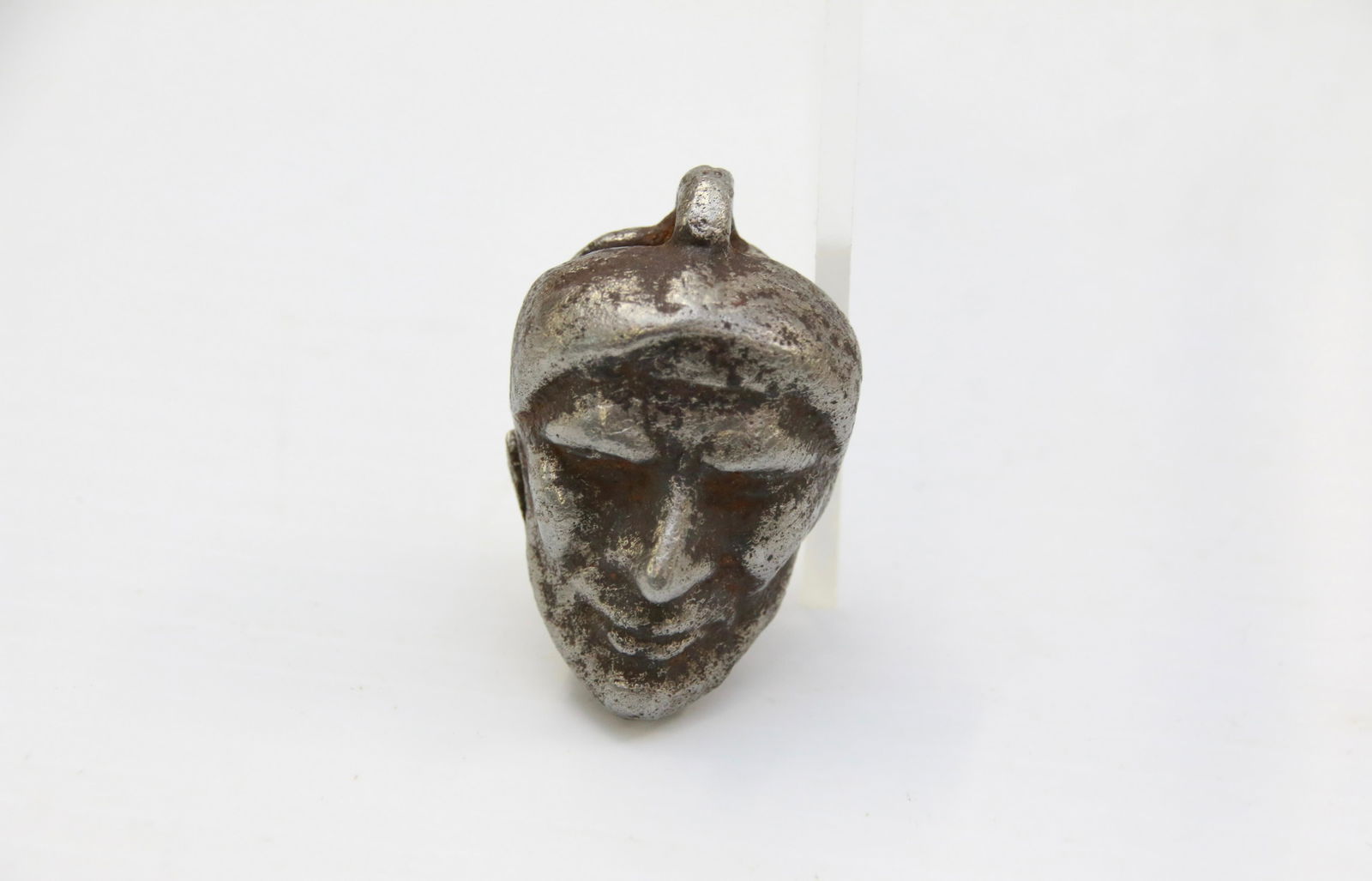 CAST IRON CAP BOMB: PAINTED SILVER - IN THE FORM OF A NATIVE AMERICAN Size: 1 1/2" X 1"