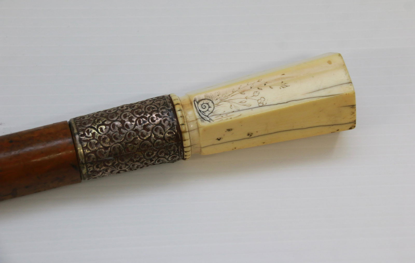 ANTIQUE BONE TOP CANE / WALKING STICK: MALACCA CANE WITH BONE TOP AND SPIRIT LEVEL INSIDE - BONE TOP IS 6 SIDED WITH BUTTERFLY, SNAIL, AND SWAN DESIGN -SILVER BANDED Size: 34 1/4"