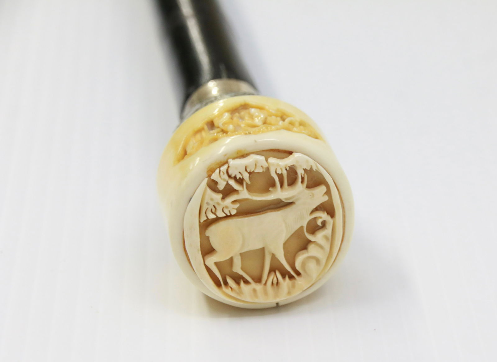 ANTIQUE BONE AND SILVER TOP CANE: 19TH CENTURY EBONY SHAFT CANE WITH CHINESE CARVED BONE TOP OF STAG AND SILVER BASE - INTERIOR WHISTLE Size: 37 3/4"