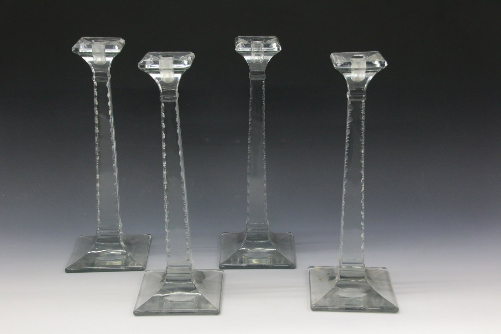 LARGE GLASS CANDLESTICKS: FOUR CANDLESTICKS, EDWARDIAN STYLE, POLISHED AND CUT. PROBABLY HEISEY. Size: 15 1/4”