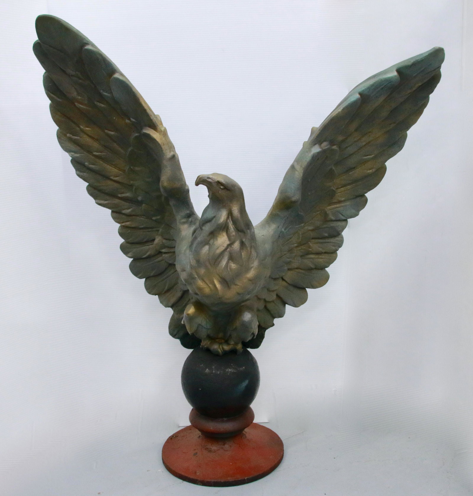 CAST BRONZE EAGLE ON BASE: PAINTED BRONZE OR BRASS HOLLOW CAST EAGLE ON CAST IRON BALL BASE Size: EAGLE 34" X 36"