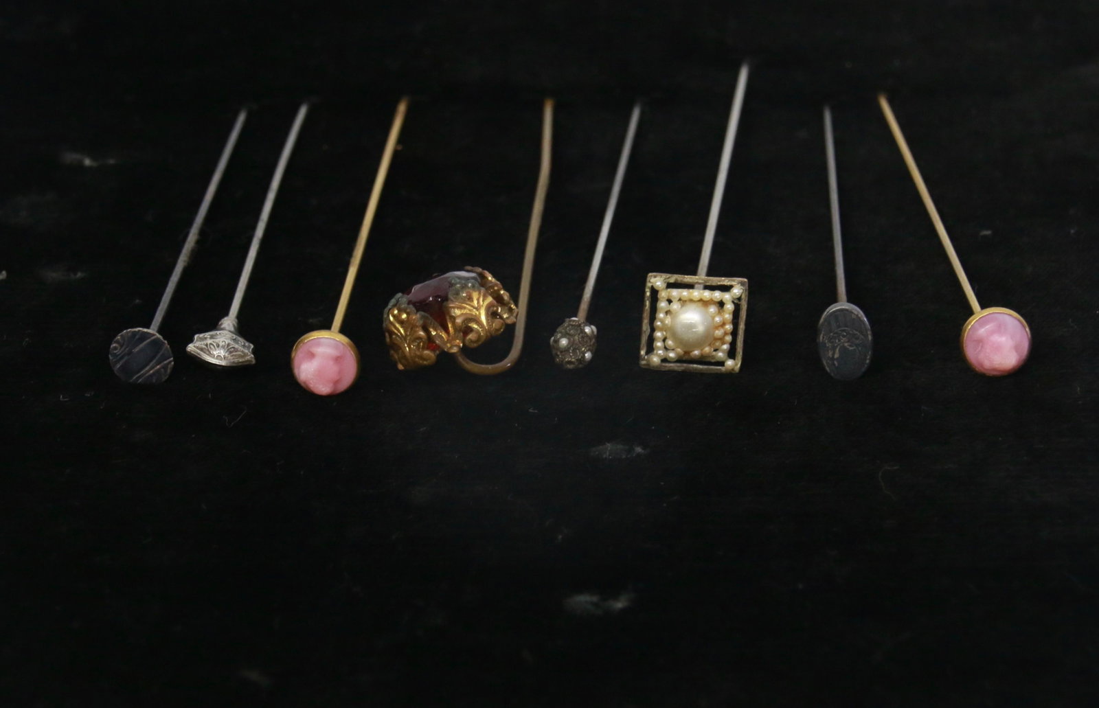 EARLY HATPIN LOT: (8) HATPINS INCLUDING - SET RUBY STONE, (3) STERLING TOPS, (2) WITH FAUX PEARLS, AND (2) PINK GLASS CAMEOS 6" TO 7"