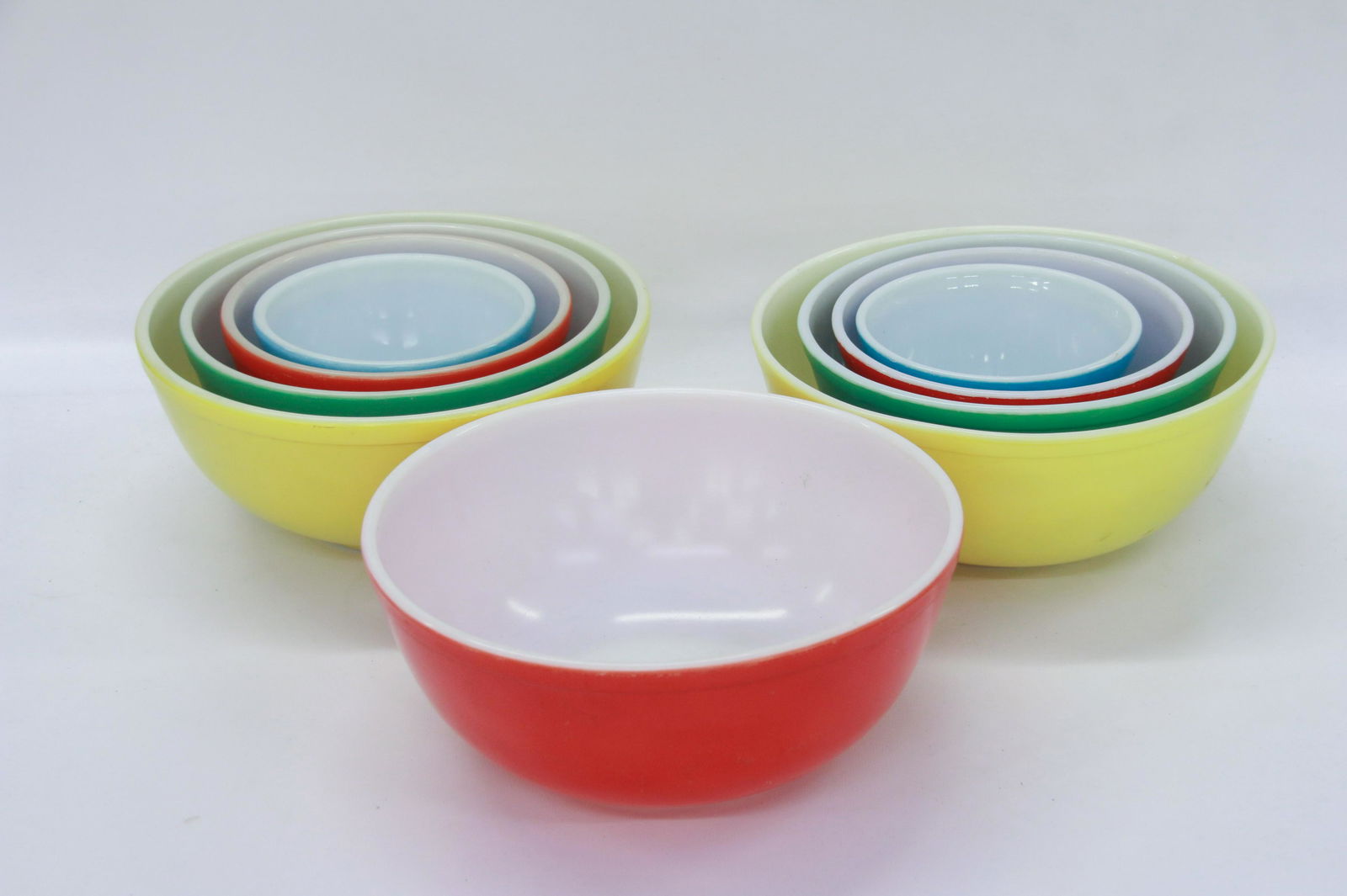 GROUP LOT OF PYREX BOWLS: NINE BOWLS. TWO NESTS AND ONE LARGE RED 5 5/8" TO 10 1/4"