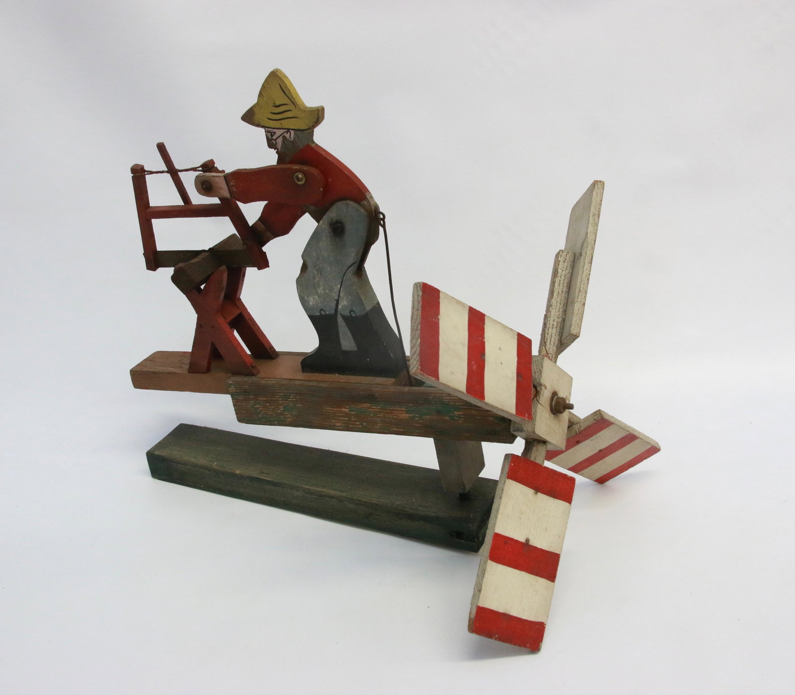 FOLK ART WOODEN WHIRLIGIG: DEPICTS A MAN SAWING WOOD 16" X 15"