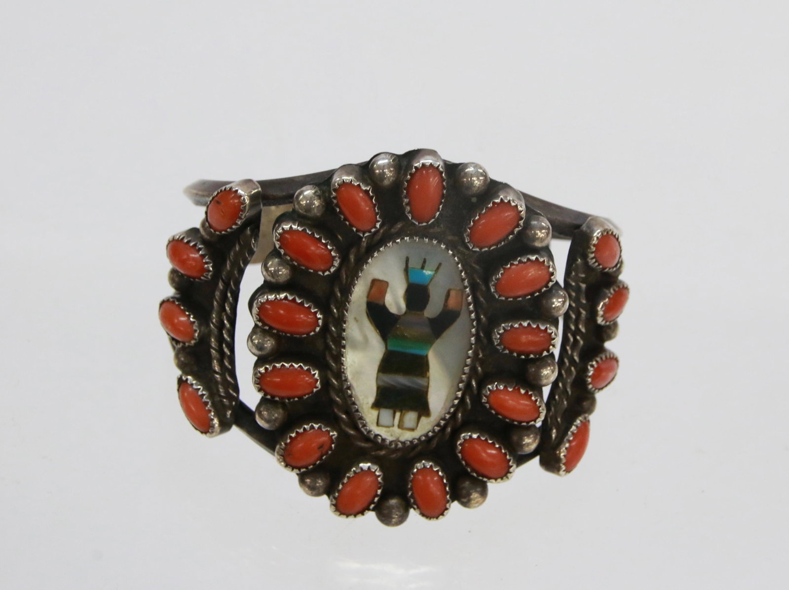 NATIVE AMERICAN ZUNI CUFF: HANDWROUGHT. 1.74 OZT. CARNELIAN STONES. KACHINA FIGURE. SIGNED E.B. PROCEEDS BENEFIT BAR HARBOR MAINE MUSIC FESTIVAL 2 1/2" X 2 1/4"