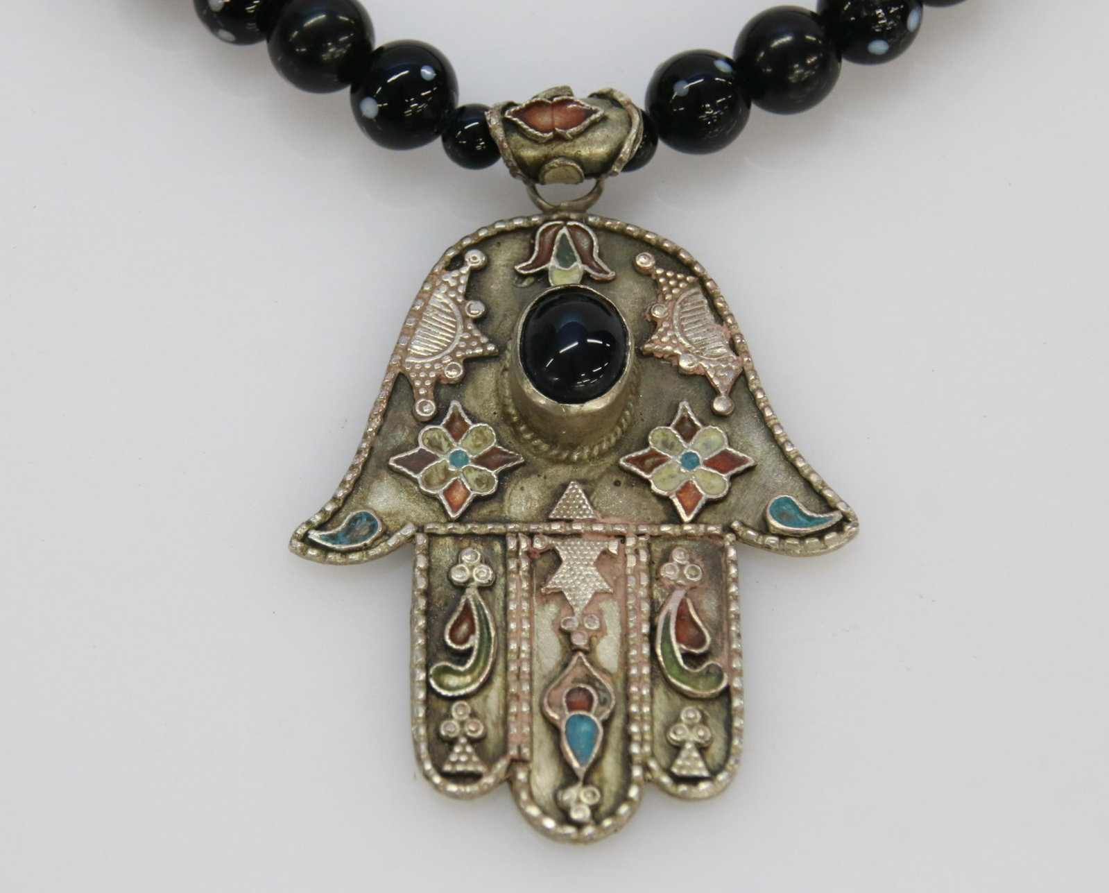 ENAMELED MIDDLE EASTERN NECKLACE: HAND OF FATIMA". GLASS BEADS AND METAL. PROCEEDS BENEFIT BAR HARBOR MAINE MUSIC FESTIVAL 20" LENGTH. PENDANT 2 3/4" X 2
