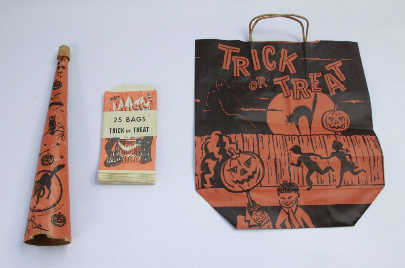 GROUP LOT OF PAPER HALLOWEEN ITEMS: INCLUDING: TWENTY-FIVE TREAT BAGS, PAPER HORN (PAT'D 1921) AND LARGE TREAT BAG Size: HORN MEASURES 14 1/2".