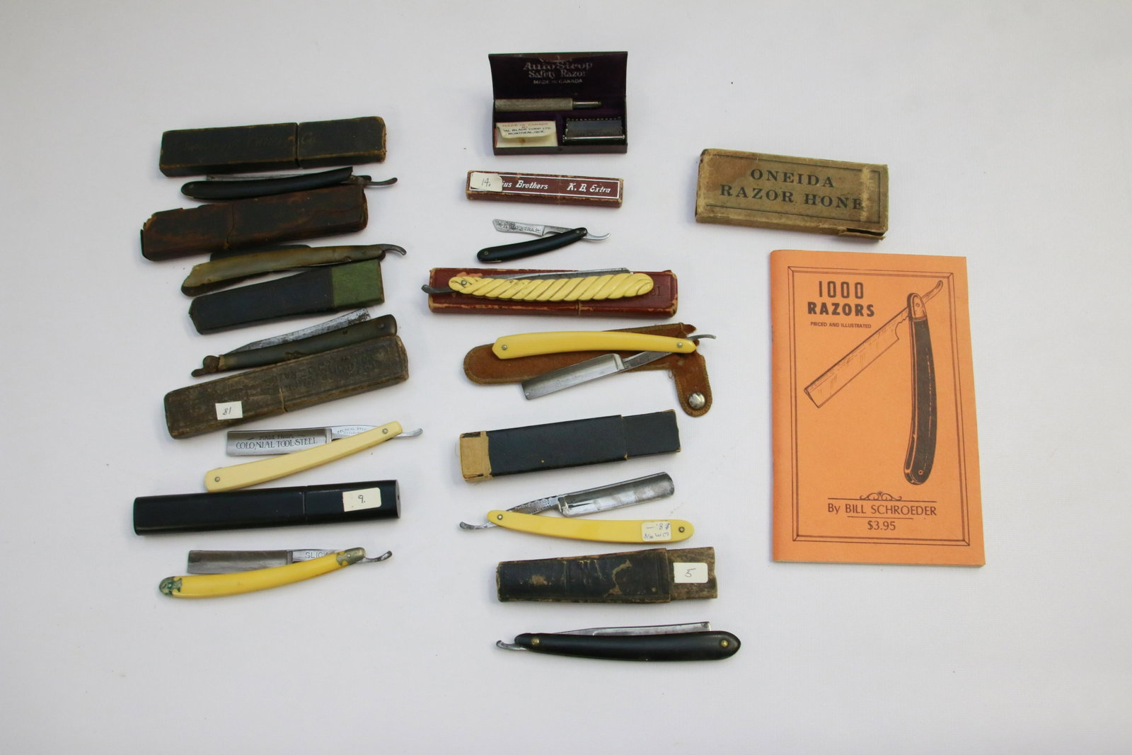 GROUP LOT OF STRAIGHT RAZORS: INCLUDES: SCOUT, BAGSHAW, BRANDT'S, SEARS, COLONIAL, SLICK AND MORE. AUTO SHARP RAZOR IN CASE, ONEIDA RAZOR HONE AND REFERENCE BOOK ON RAZORS.