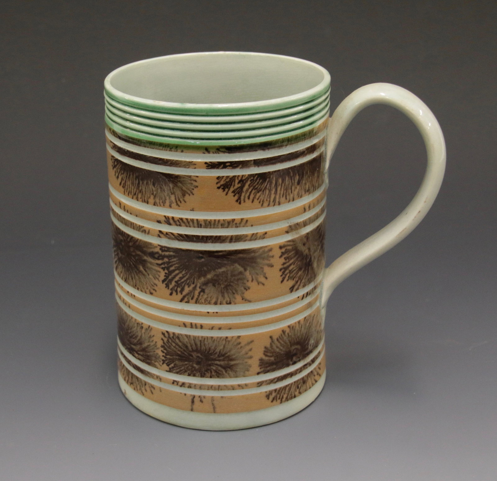 19TH CENTURY LARGE MOCHAWARE MUG: WITH BROWN SEAWEED DECORATION, 10 WHITE LINES , AND OCHRE BACKGROUND Size: 6" H X 4" D We do not give IN-HOUSE shipping quotes. Please email japakmail@earthlink.net - All items once paid will be taken