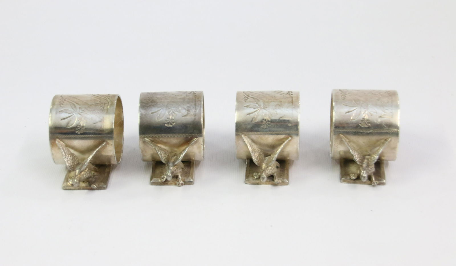 (4) FIGURAL NAPKIN RINGS: FIGURAL NAPKIN RINGS WITH DOVES - ROGERS BROTHERS Size: 2" X 3.5" Important Shipping Information: We do not give IN-HOUSE shipping quotes. Please email japakmail@earthlink.net - All items once paid