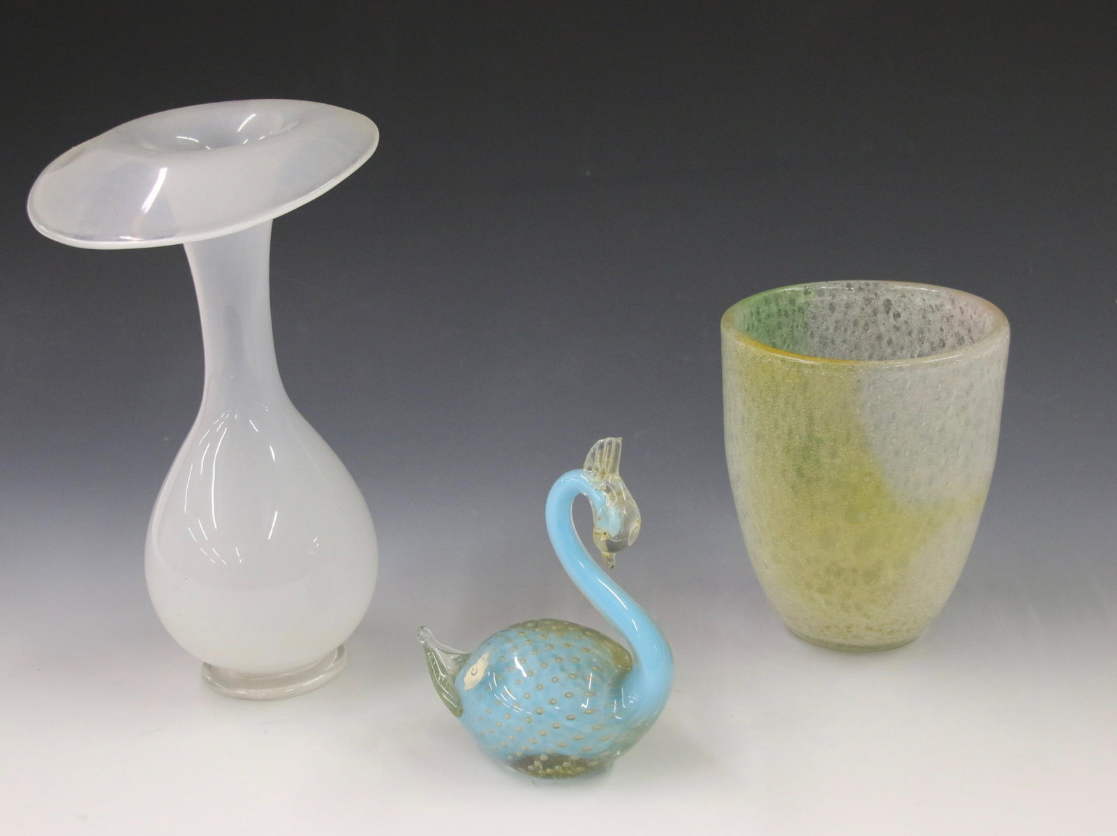 EARLY GLASS LOT: ORREFORS SIGNED VASE, VENETIAN SWAN IN GOLD AND BLUE, AND CLUTHRA VASE IN LIGHT GREEN AND YELLOW WITH POLISHED PONTIL Size: 9" X 5" - 5 1/4" X 4" - 5 1/2" X 4 1/2" Important Shipping Information: We d