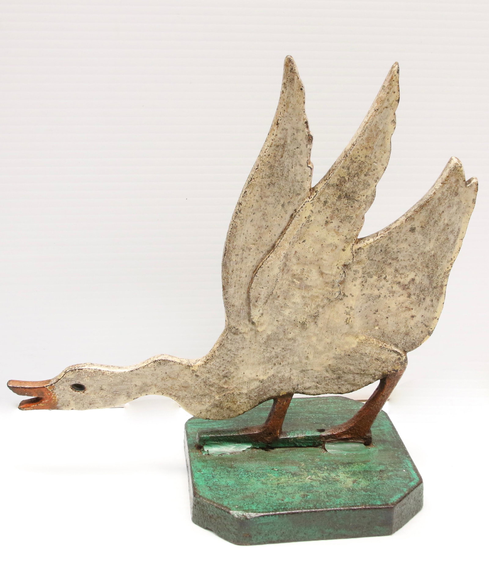 20TH CENTURY GOOSE DOOR STOP: "FLYING" GOOSE DOOR STOP, CIRCA 1920 IN ORIGINAL PAINT - CAST IRON Dimensions: 10 1/2" H X 9 1/2" W