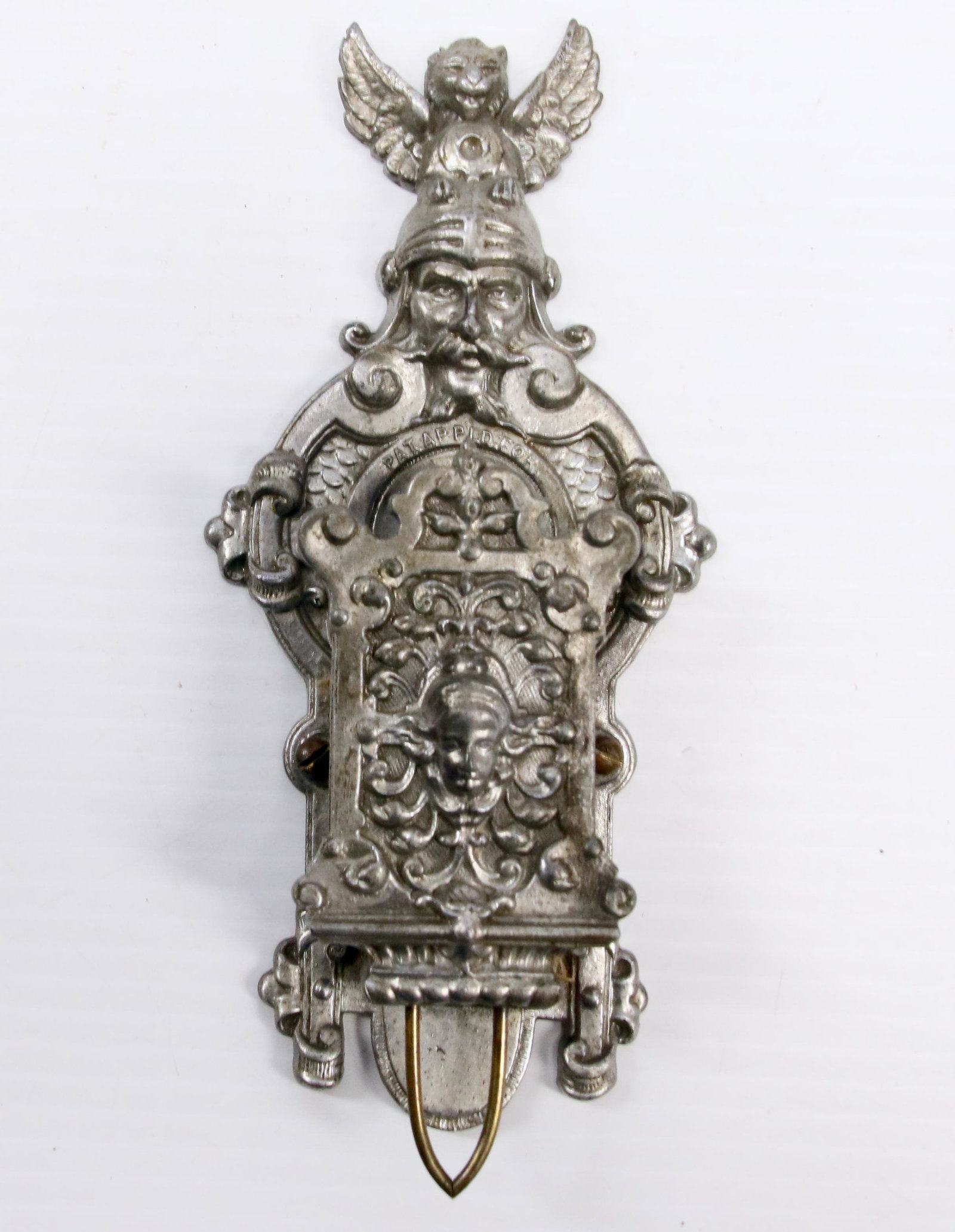 EARLY BRASS FIGURAL MATCH HOLDER: 19TH CENTURY MATCH HOLDER OF SOLDIER WITH LIONS HEAD AND WINGS - CHERUB ON FRONT - MARKED PATENT APPLIED FOR - PAINTED GREY Dimensions: 7 1/4"