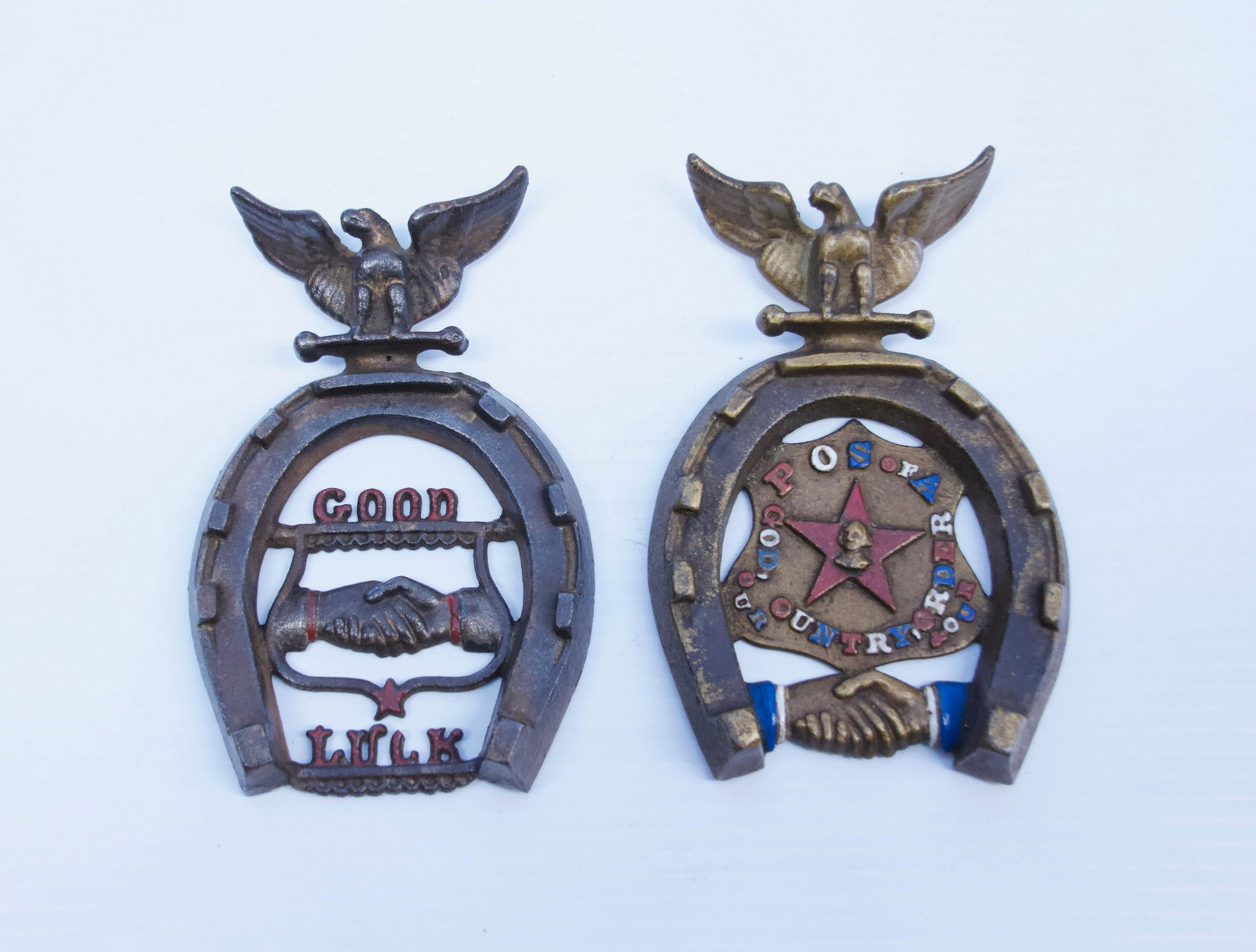 PAIR OF CAST IRON HORSESHOE PAPERWEIGHTS: PAINTED HIGHLIGHTS. HORSESHOE WITH EAGLE AT TOP. POS OF A AND GOOD LUCK Dimensions: 7" X 4"
