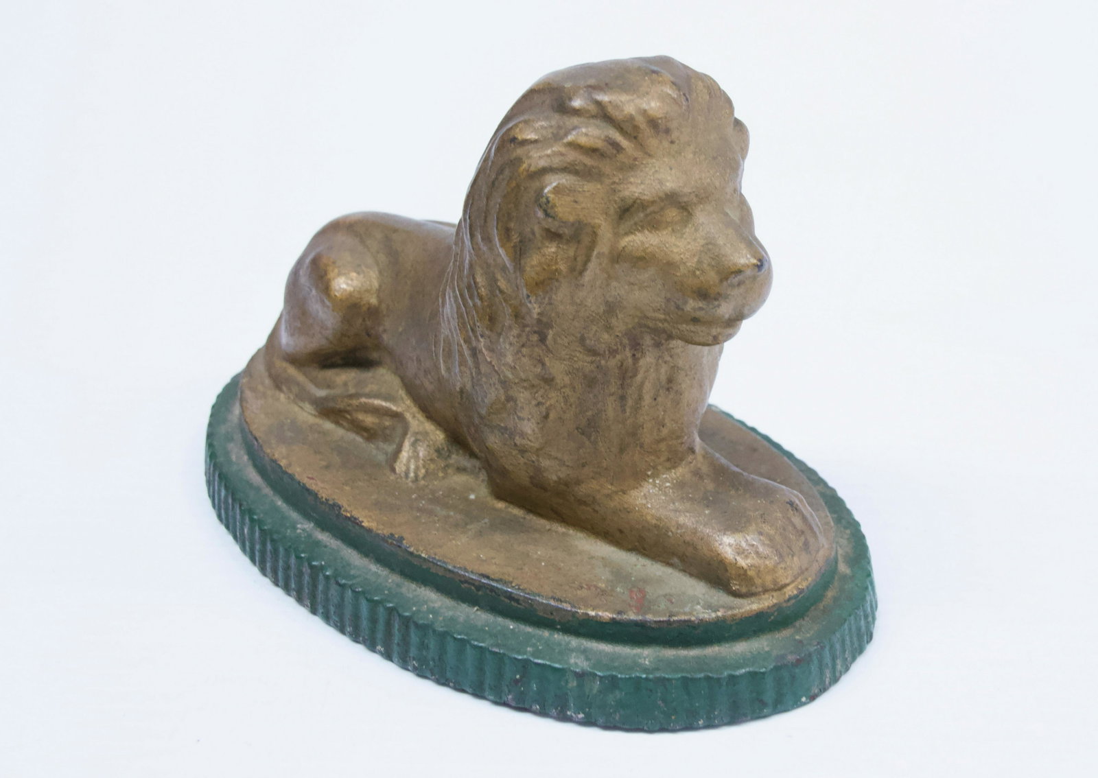 19TH CENTURY LION DOORSTOP: PAINTED CAST IRON WITH RIBBED BASE Dimensions: 5" X 7"