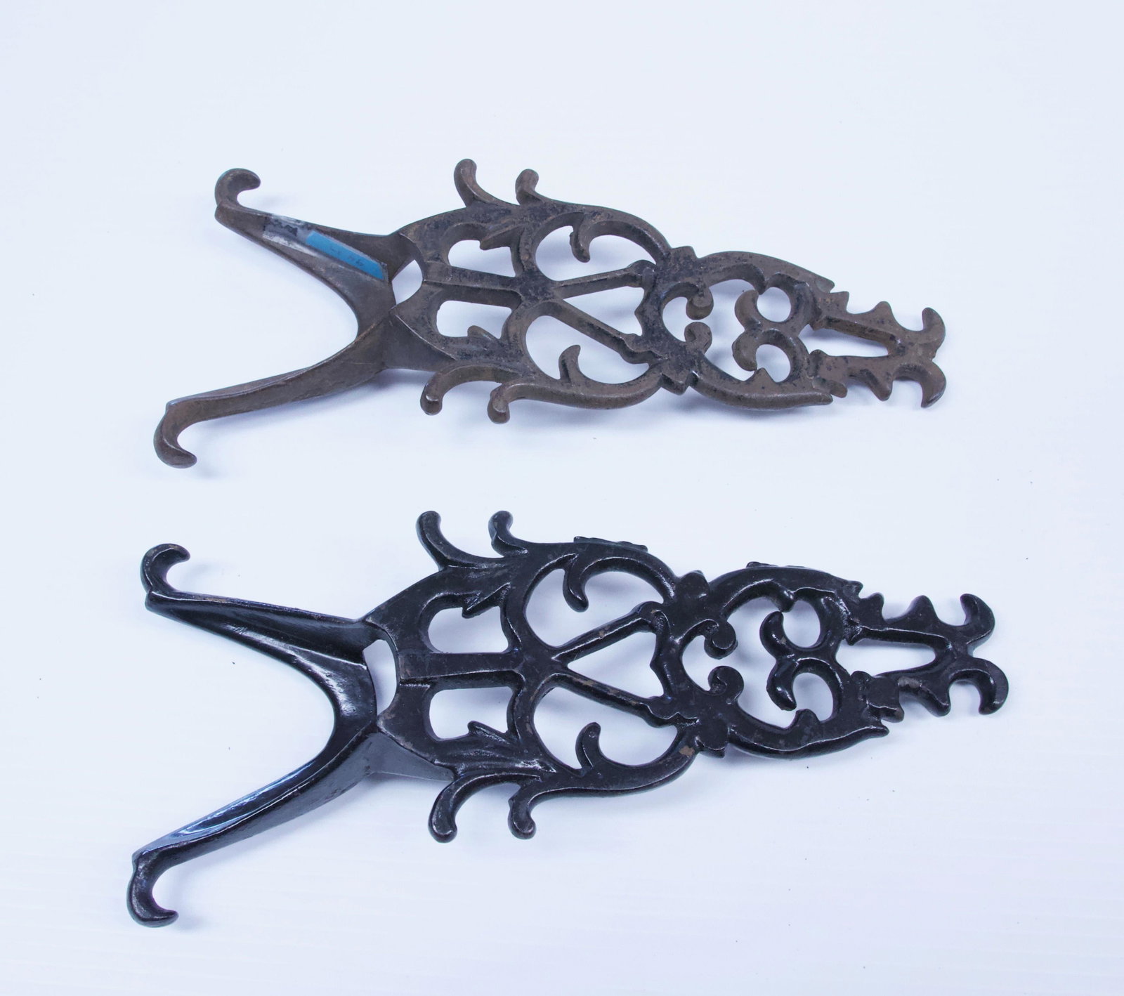 PAIR OF CAST IRON BOOT JACKS: FANCY SCROLL WORK Dimensions: 10 3/4" L