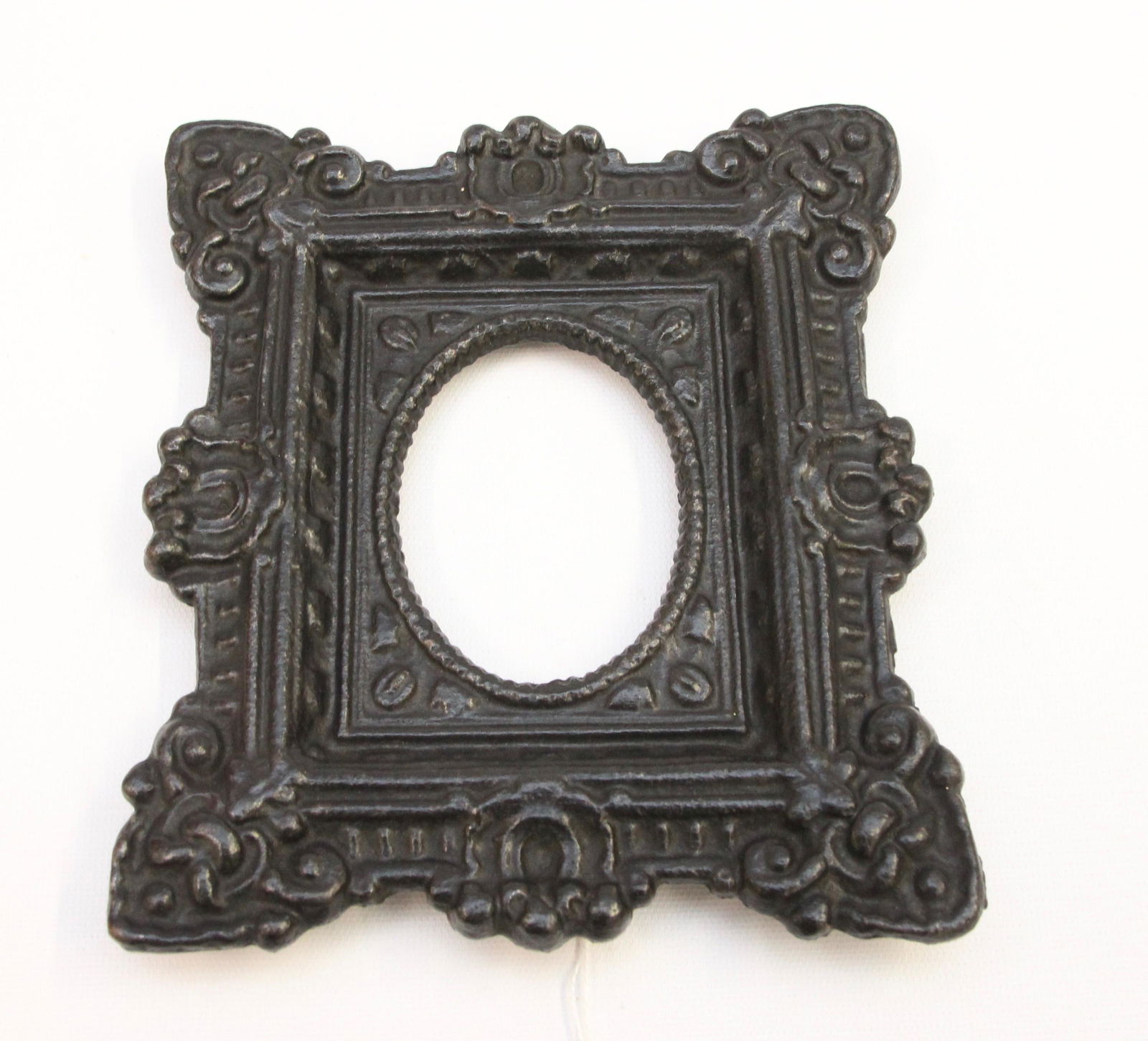 CAST IRON ORNATE FRAME: PAINTED BLACK. Dimensions: 3 1/4' X 2 1/2" OPENING AND 8" X 7" TOTAL
