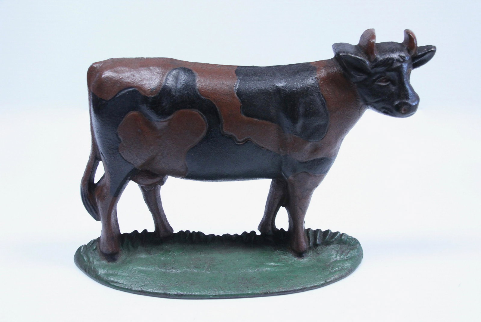 CAST IRON COW DOORSTOP: PAINTED IRON Dimensions: 7 1/4" X 12"
