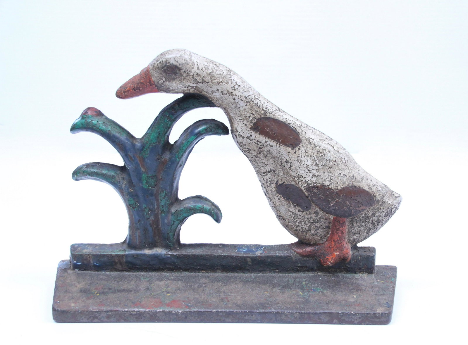 CAST IRON GOOSE DOORSTOP: GOOSE WITH LADYBUG. PAINTED IRON Dimensions: 7 1/2" X 10"