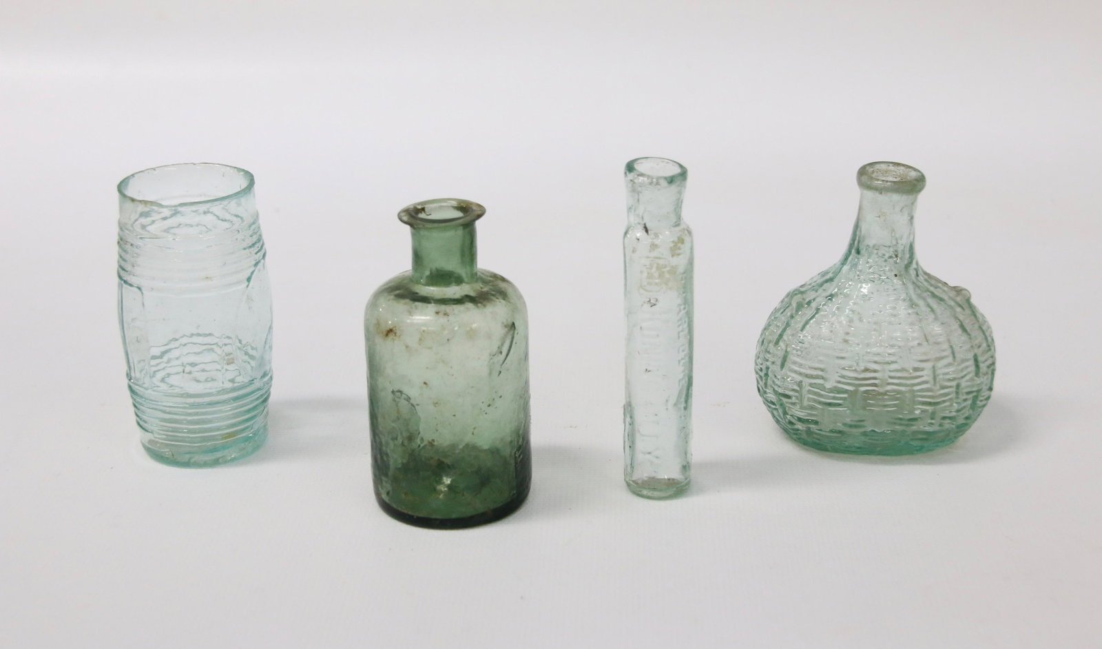 (4) EARLY SMALL BOTTLES: BARREL SHAPED STORAGE JAR - OLIVE GREEN WITH PONTIL - AQUA CARBOY SHAPE WITH PONTIL - AQUA VIAL TYPE