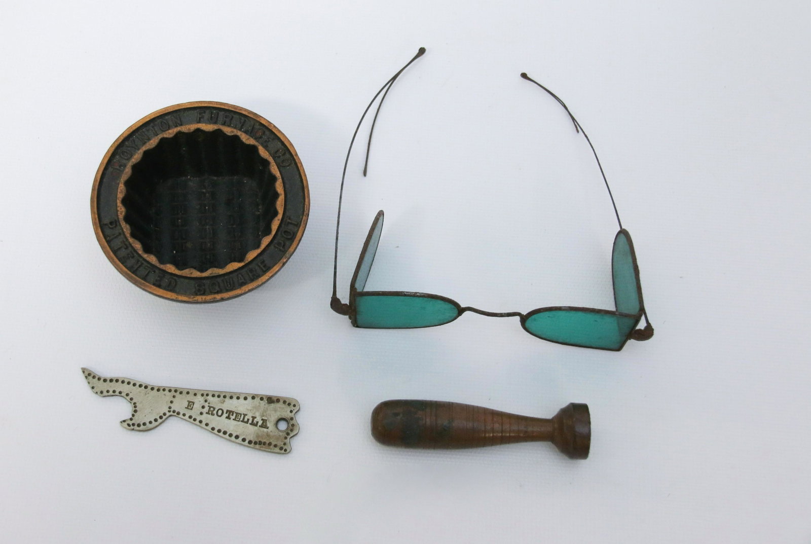 GROUP LOT OF SMALLS: FOUR ITEMS INCLUDING: EARLY SUNGLASSES, BOOT SHAPED OPENER, BOYNTON'S FURNACE SQUARE POT ADVERTISER AND BRASS "PRESS" Dimensions: GLASSES 4 1/2" L