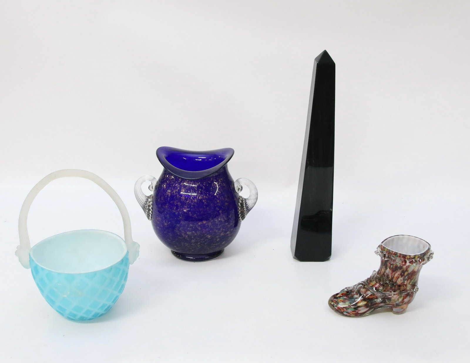 GROUP LOT OF ART GLASS: FOUR PIECES INCLUDING: BLACK GLASS OBELISK, COBALT TWO HANDLED VASE, CASED END OF DAY SHOE AND SATIN BASKET Dimensions: OBELISK 12", VASE 6 1/2" X 7", SHOE 3 3/4" X 5 1/2" AND BASKET 8" X 5 1/2"