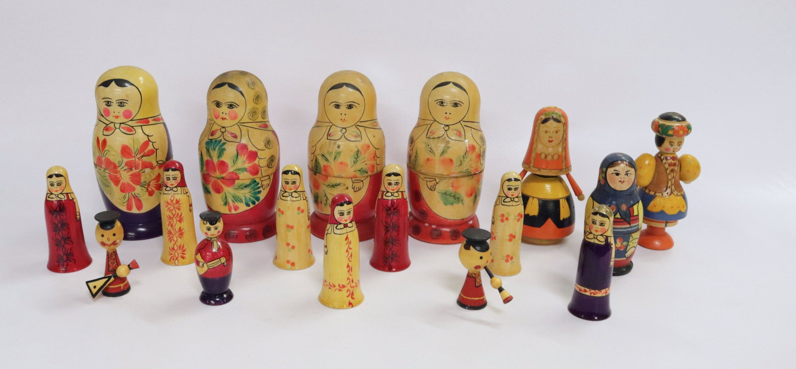 GROUP LOT OF RUSSIAN WOODEN FIGURES: SEVENTEEN INCLUDING: RUSSIAN NESTING DOLLS MRKD. USSR, MAN&WOMAN MRKD. USSR, AND OTHERS 2 1/2" TO 6 1/4" H