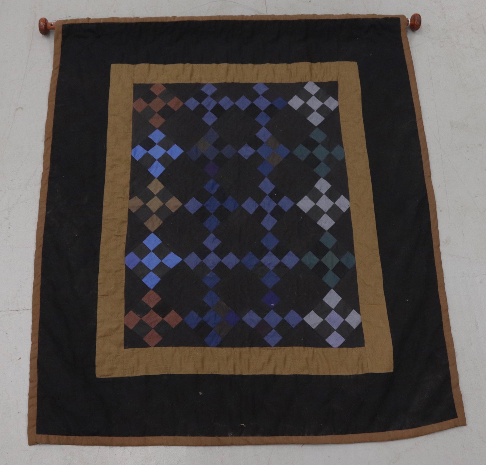 CRIB SIZE AMISH QUILT: HAND STITCHED QUILT WITH BLACK, TAN, AND BLUES - WOODEN HANGER THROUGH TOP - HAND SEWN HANGER 36" X 41 1/2"
