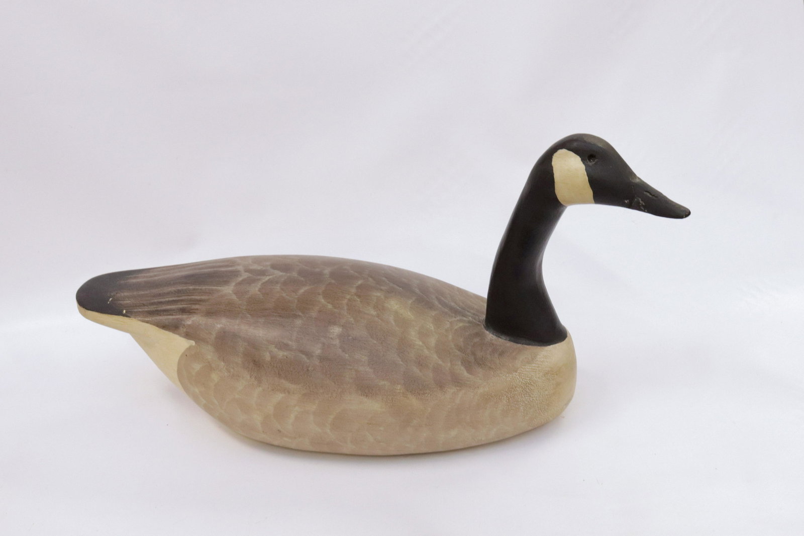 VINTAGE WOODEN GOOSE DECOY: CARVED WOOD - HAND PAINTED - BRANDED "KL" ON BOTTOM 12 1/2" X 26 1/2"