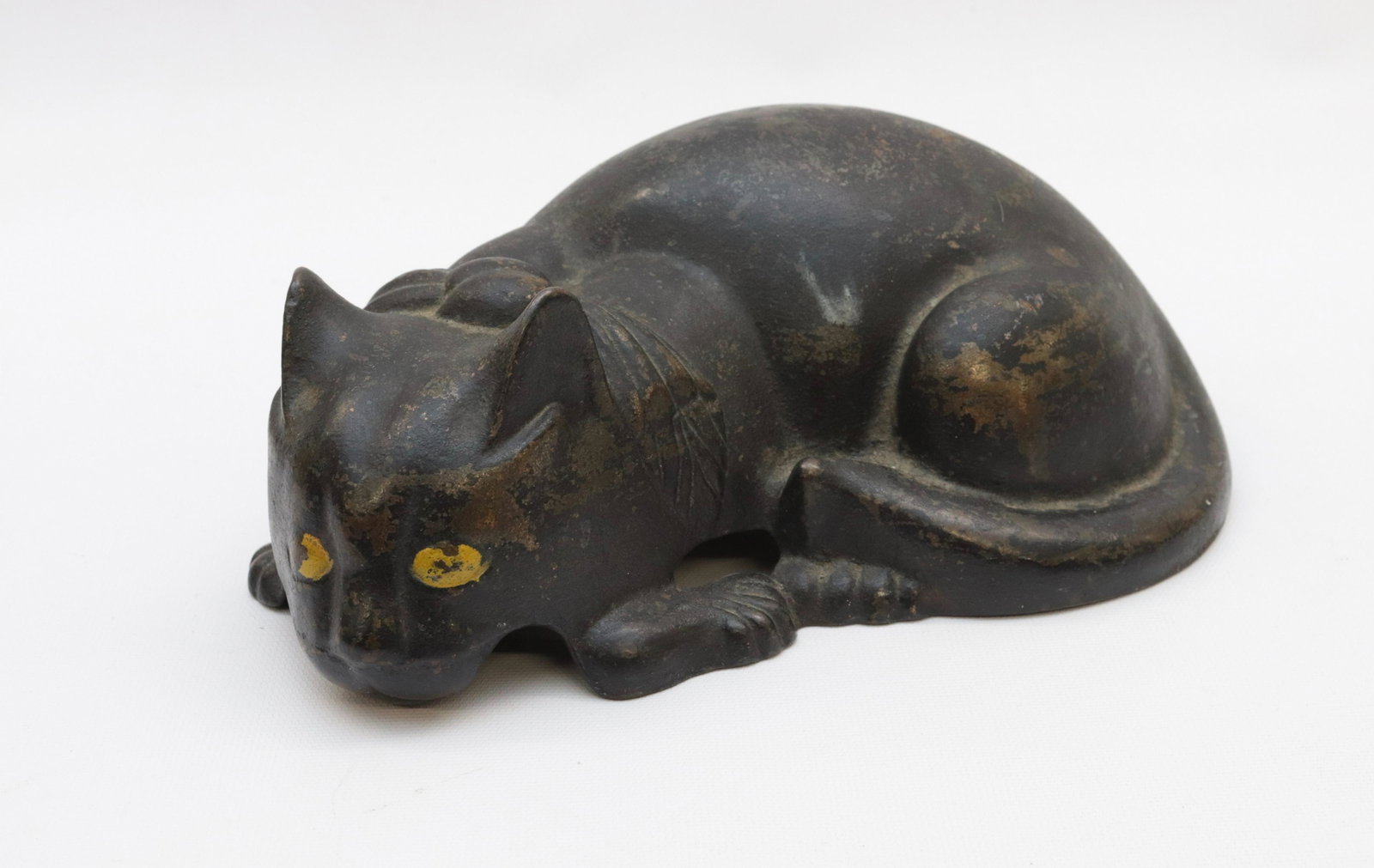CAST IRON CAT DOORSTOP: CAT LAYING DOWN - PAINTED BLACK WITH YELLOW EYES AND HOLLOW BODY 10" L