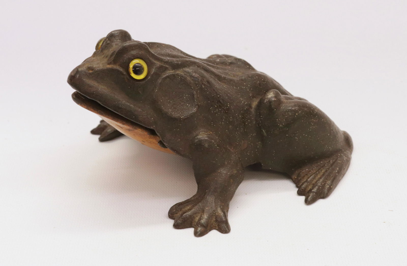 CAST IRON FROG DOORSTOP: PAINTED CAST IRON WITH GLASS EYES - SIGNED EAST HAMPTON, CONNECTICUT 3" X 7" L