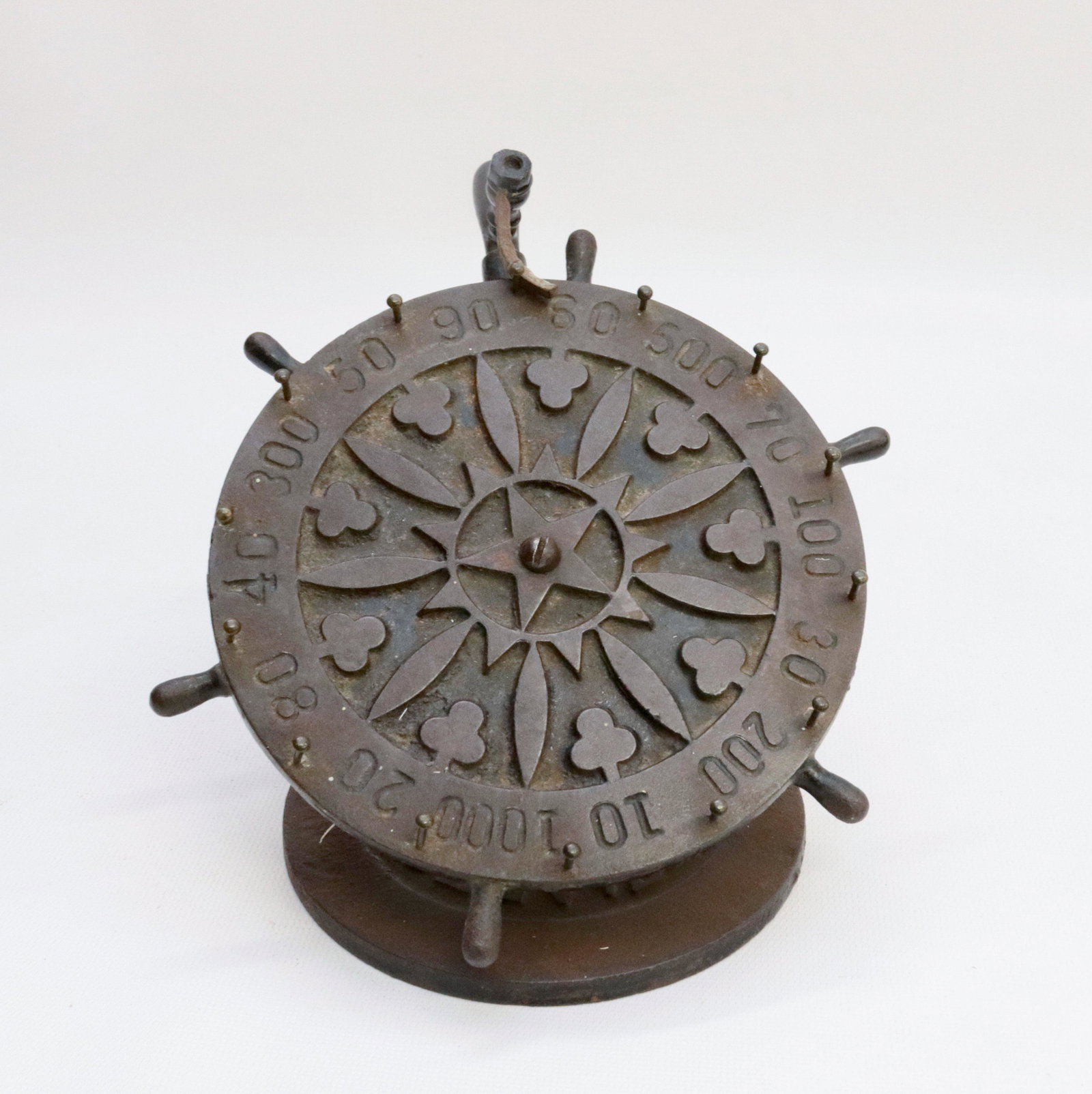 19TH CENTURY CAST IRON GAMING WHEEL: PAINTED CAST IRON WHEEL ON BASE - BASE MARKED "O.J. HURD MFR" CLEVELAND, OHIO WHEEL 7" DIAMETER - 5 3/4" H