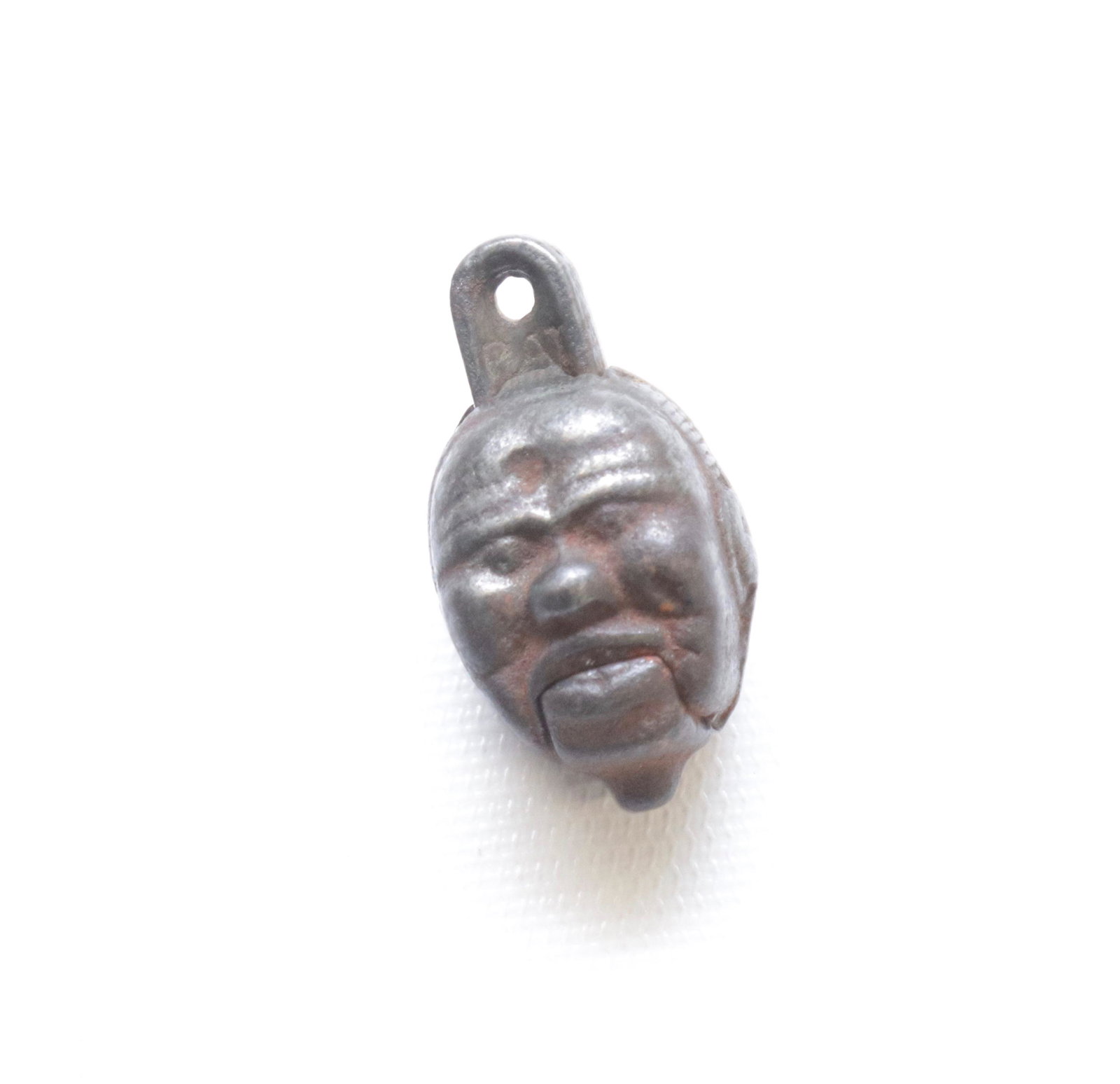 19TH CENTURY CAST IRON CAP BOMB: IN THE FORM OF A DOUBLE FACE 1 1/2"