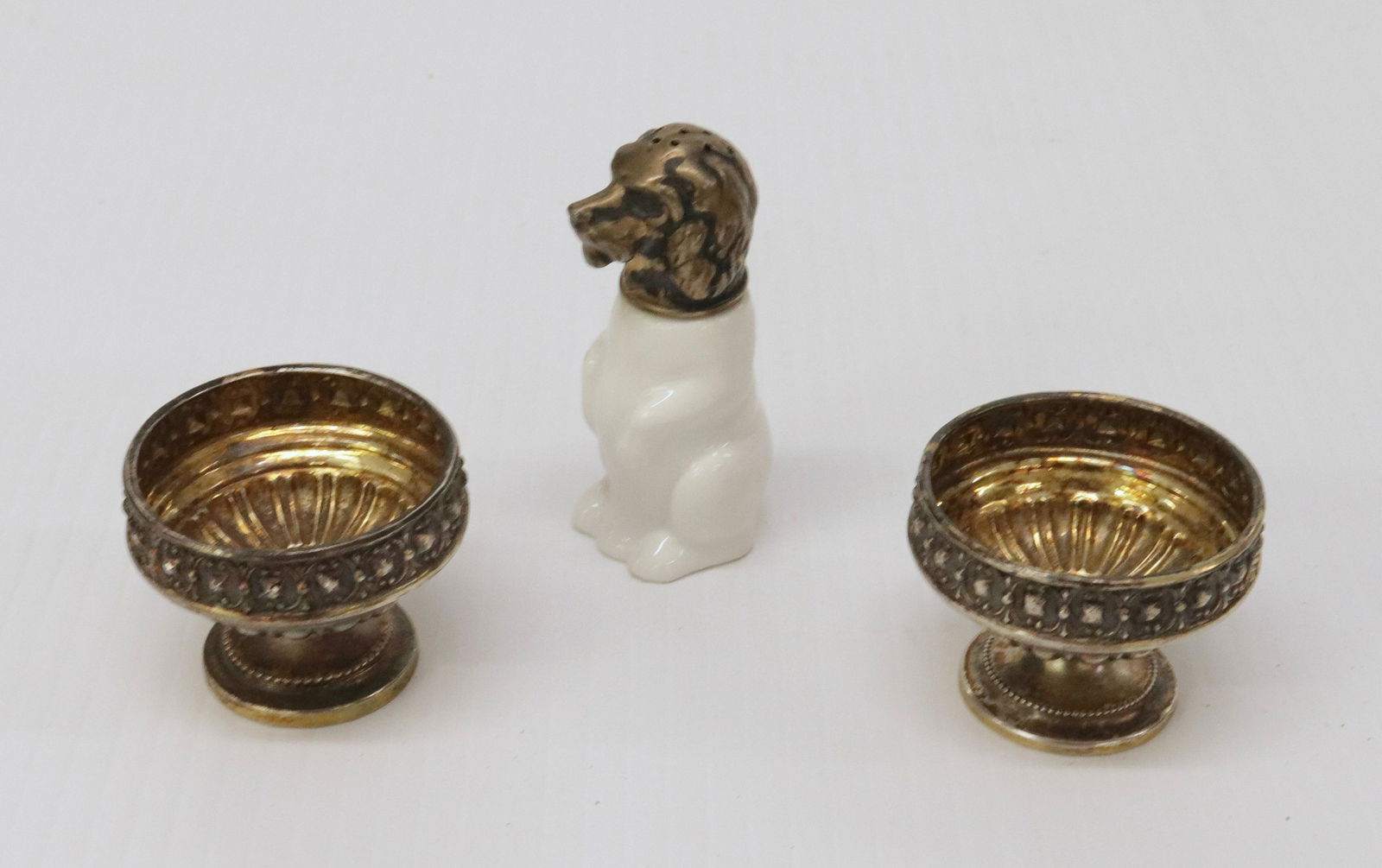 KPM SHAKER AND SALTS: KPM BERLIN FIGURAL DOG SHAKER WITH .800 LID - (2) .800 SILVER SALTS Dimensions: SHAKER 2 3/4" - OTHERS 1 1/2" X 2"