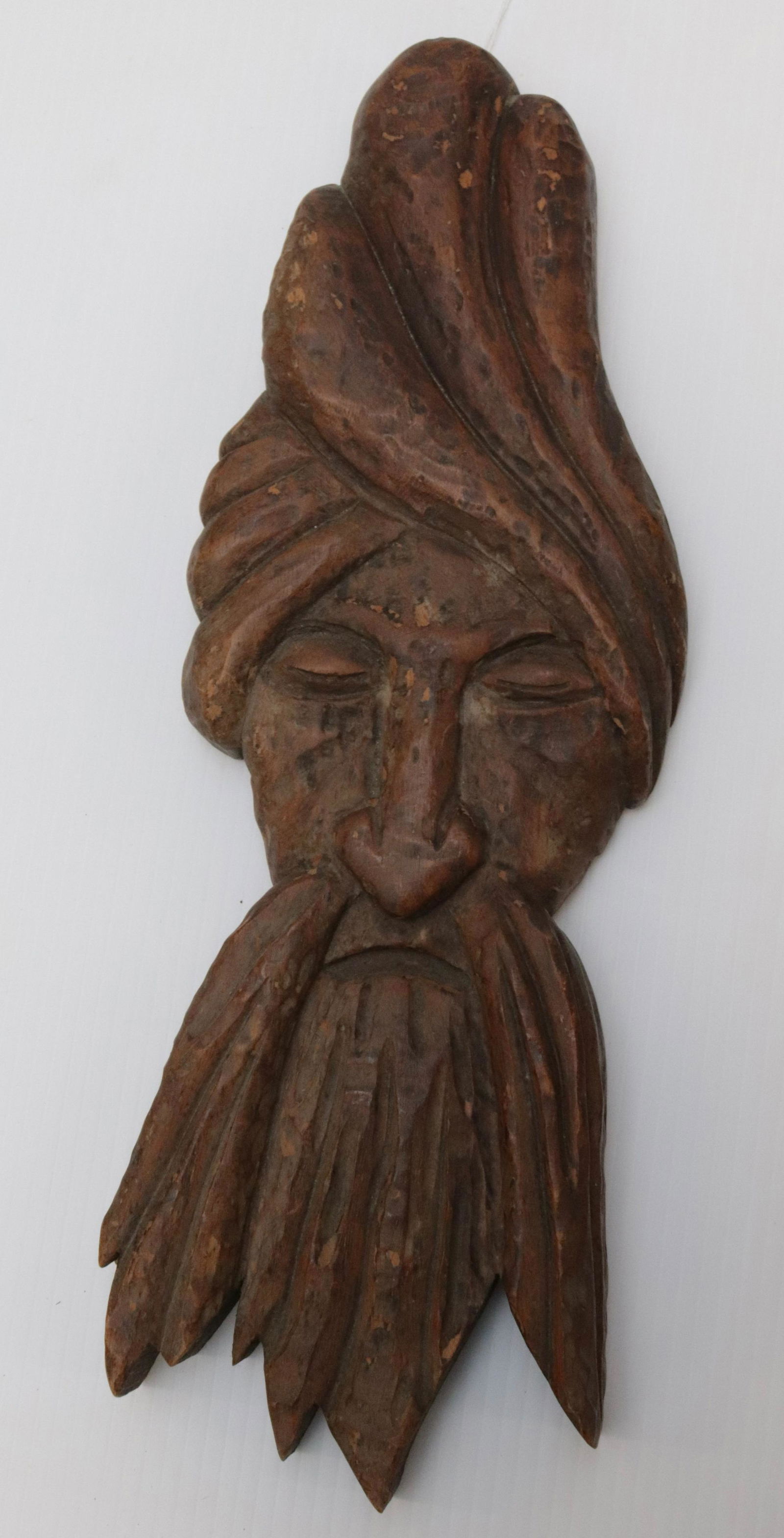CLARENCE STRINGFIELD WOODEN CARVING: CARVED FACE WITH BEARD AND CLOSED EYES. MRKD ON BACK "CARVED BY CLARENCE STRINGFIELD 1966" Dimensions: 17" L