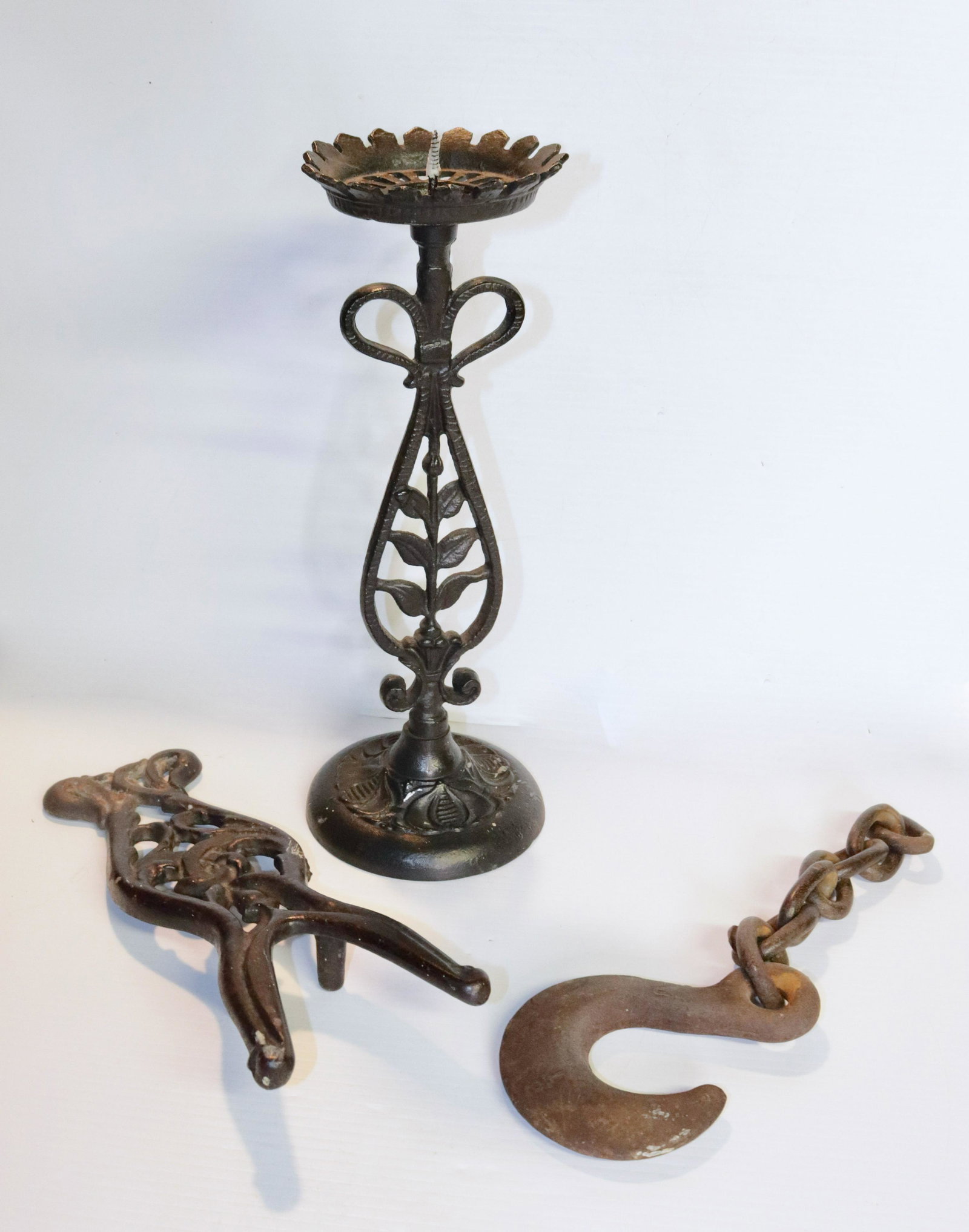 GROUP OF CAST IRON ITEMS: (3) INCLUDING - CANDLE STAND, BOOT JACK, AND HOOK SIZE: 13 3/4" H CANDLE STAND