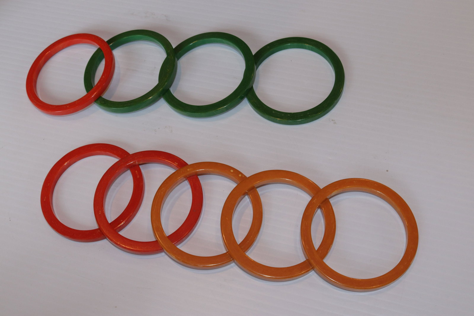 LOT OF BAKELITE BRACELETS: (9) IN GREEN, ORANGE, AND BUTTERSCOTCH SIZE: 3" DIAMETER