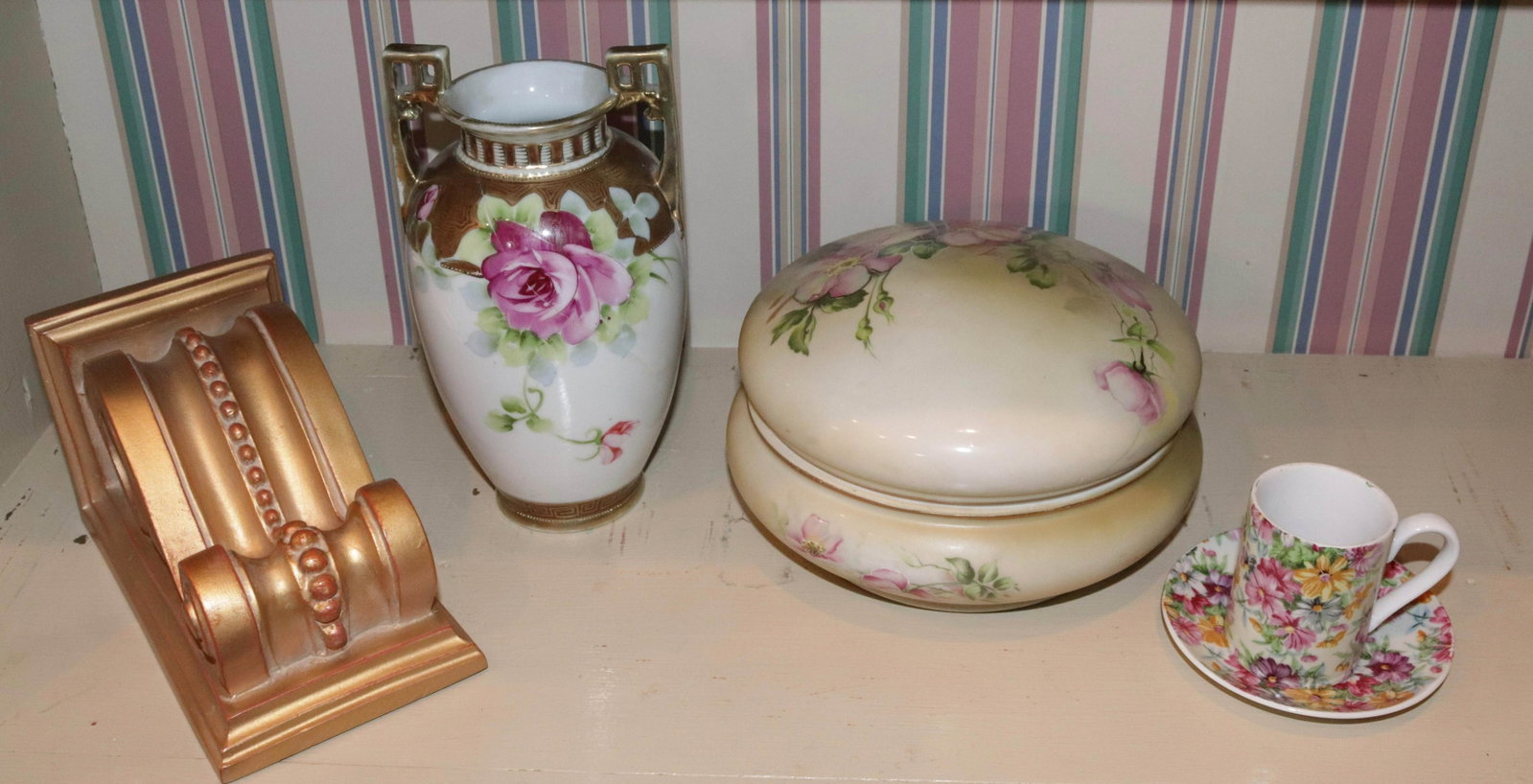 DECORATIVE ITEM LOT: (4) PIECES INCLUDING - HAND PAINTED NIPPON POWDER JAR, NIPPON VASE, CUP AND SAUCER, AND WALL BRACKET SIZE: POWDER JAR 8" D - VASE 7 1/2"