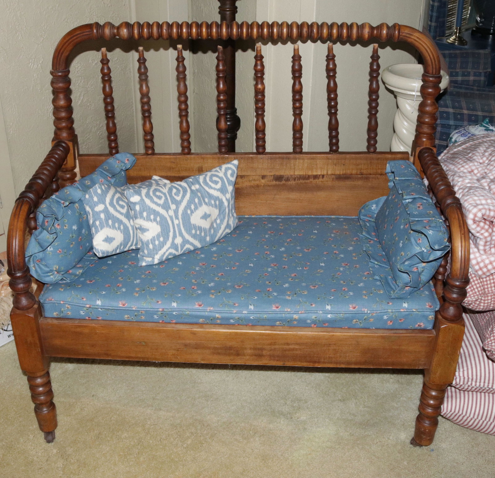 SPINDLE BENCH: BED CONVERTED TO A BENCH WITH CUSHION AND PILLOWS SIZE: 36" X 29" X 20"