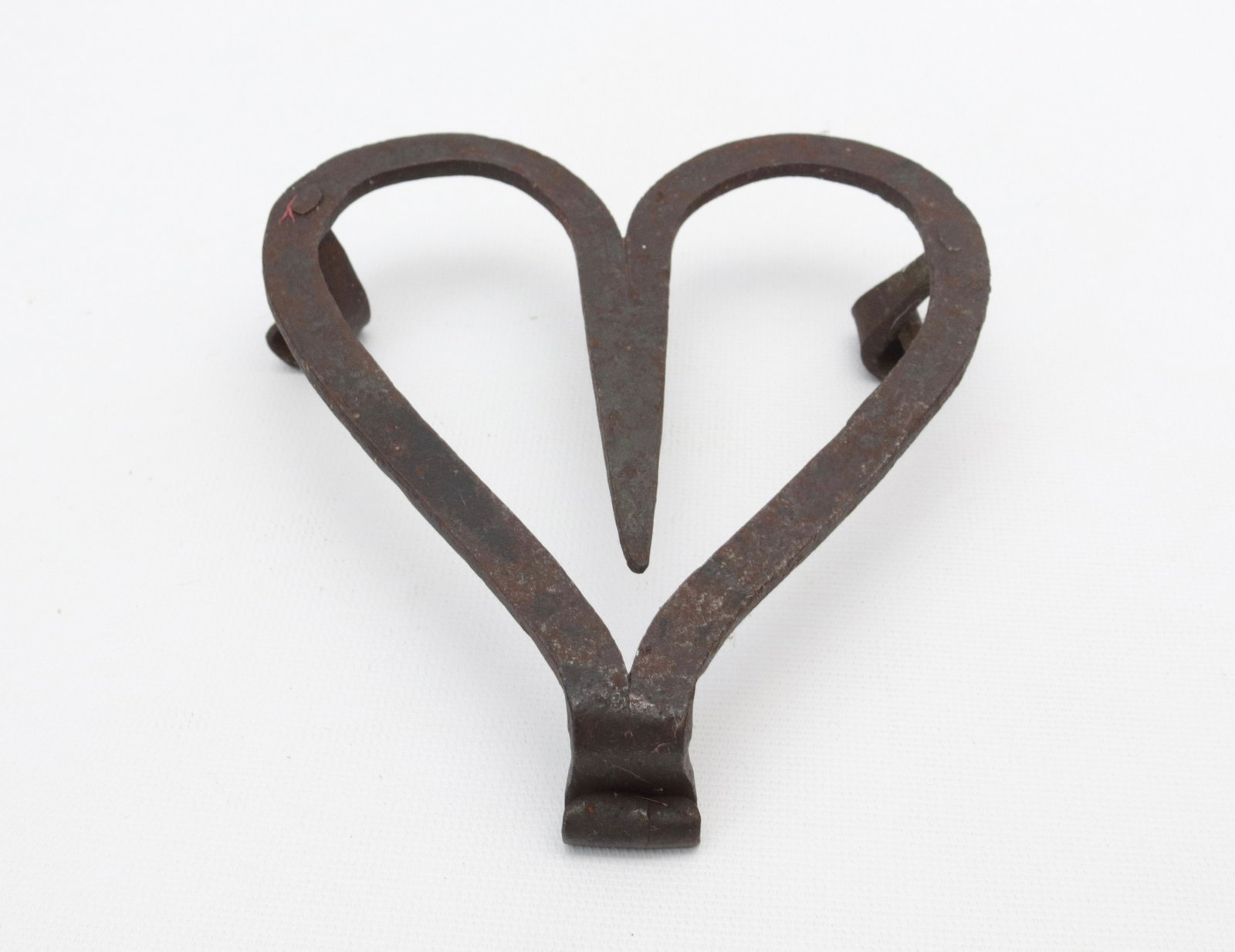 PENNSYLVANIA HEART SHAPED TRIVET: MONKEY TAIL STRAP FEET - CIRCA 1800 - WROUGHT IRON DIMENSIONS: 5 1/2" X 5"
