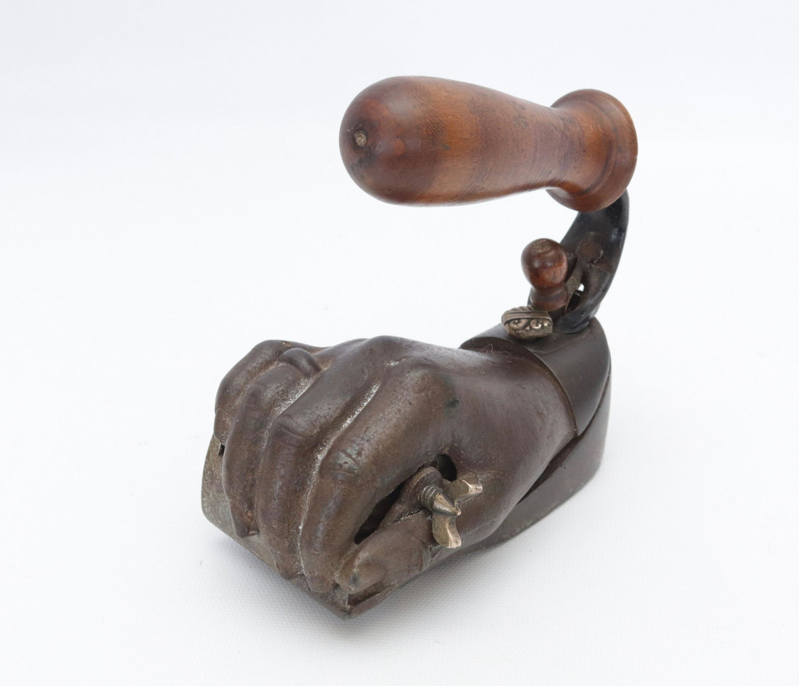 VERY RARE UNUSUAL POLISHING IRON: IN THE FORM OF A FIST HOLDING A ROLLER WITH A DETACHABLE HANDLE - MADE BY; J.G.F. LIBBY - WING NUT ON ROLLER (USED TO TIGHTEN OR LOOSEN ROLL" - GRID ON BOTTOM FOR POLISHING - BRASS CUFFLINK USED TO HO