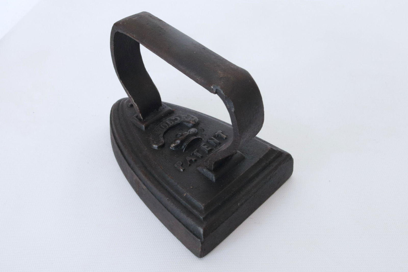 ANTIQUE CAST IRON FLAT IRON: HIGHLY EMBOSSED TOP WITH J. HOLDER AND CROWN DIMENSIONS: 6"