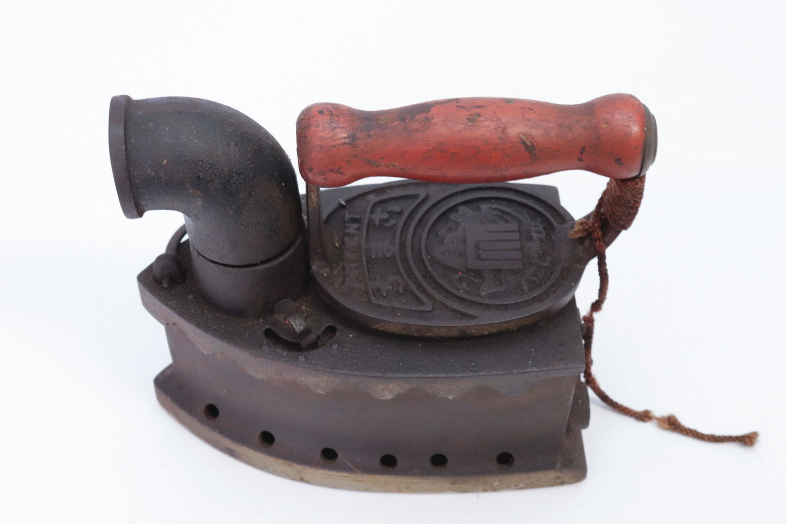 ORIENTAL CHARCOAL IRON: SWIVEL CHIMNEY AND DECORATED HEAT SHIELD DIMENSIONS: 6"