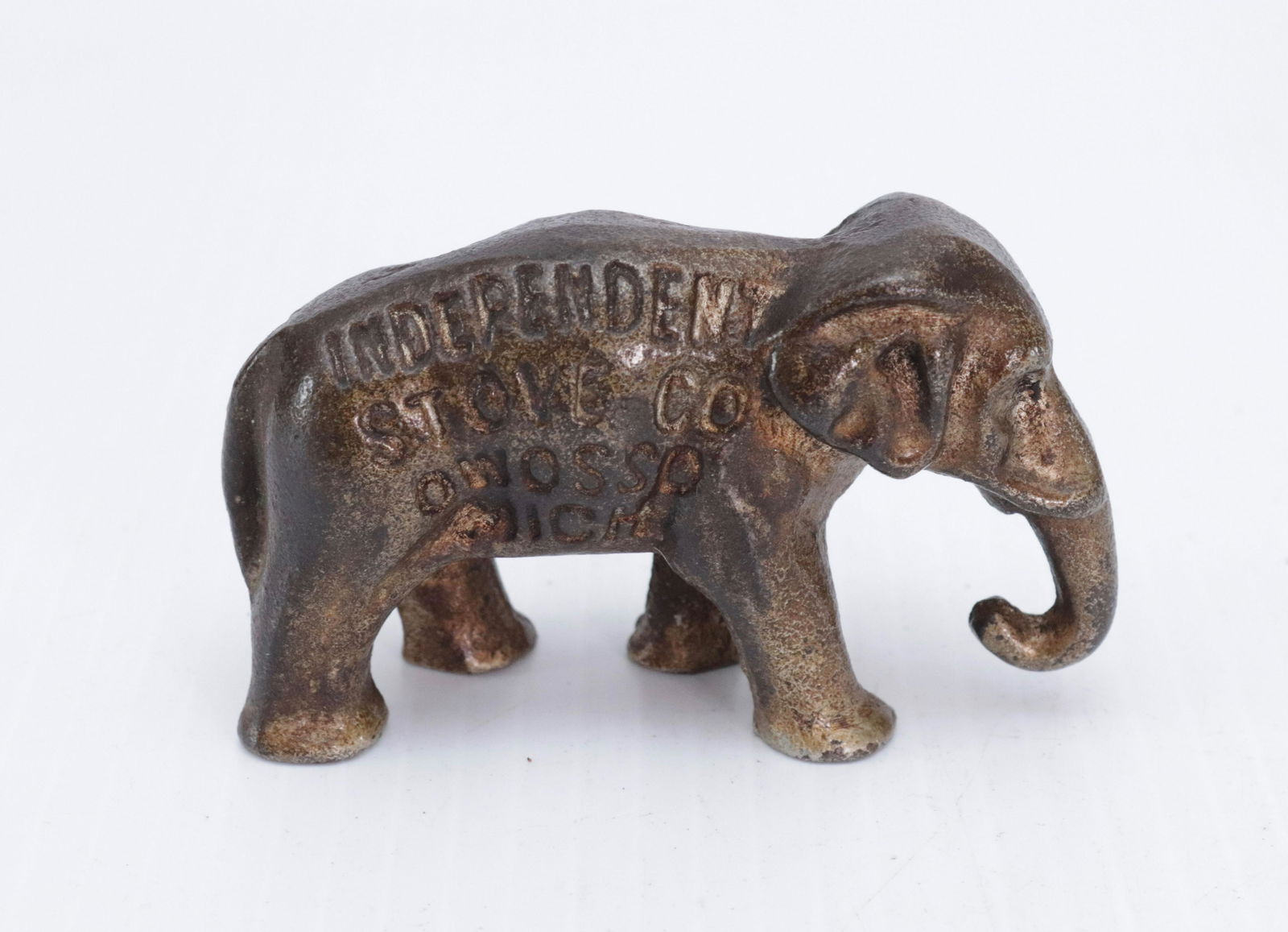 CAST IRON ADVERTISING PAPERWEIGHT: PAINTED ELEPHANT - "INDEPENDANT STOVE CO. OWOSSO, MI" 2" X 3 1/2"