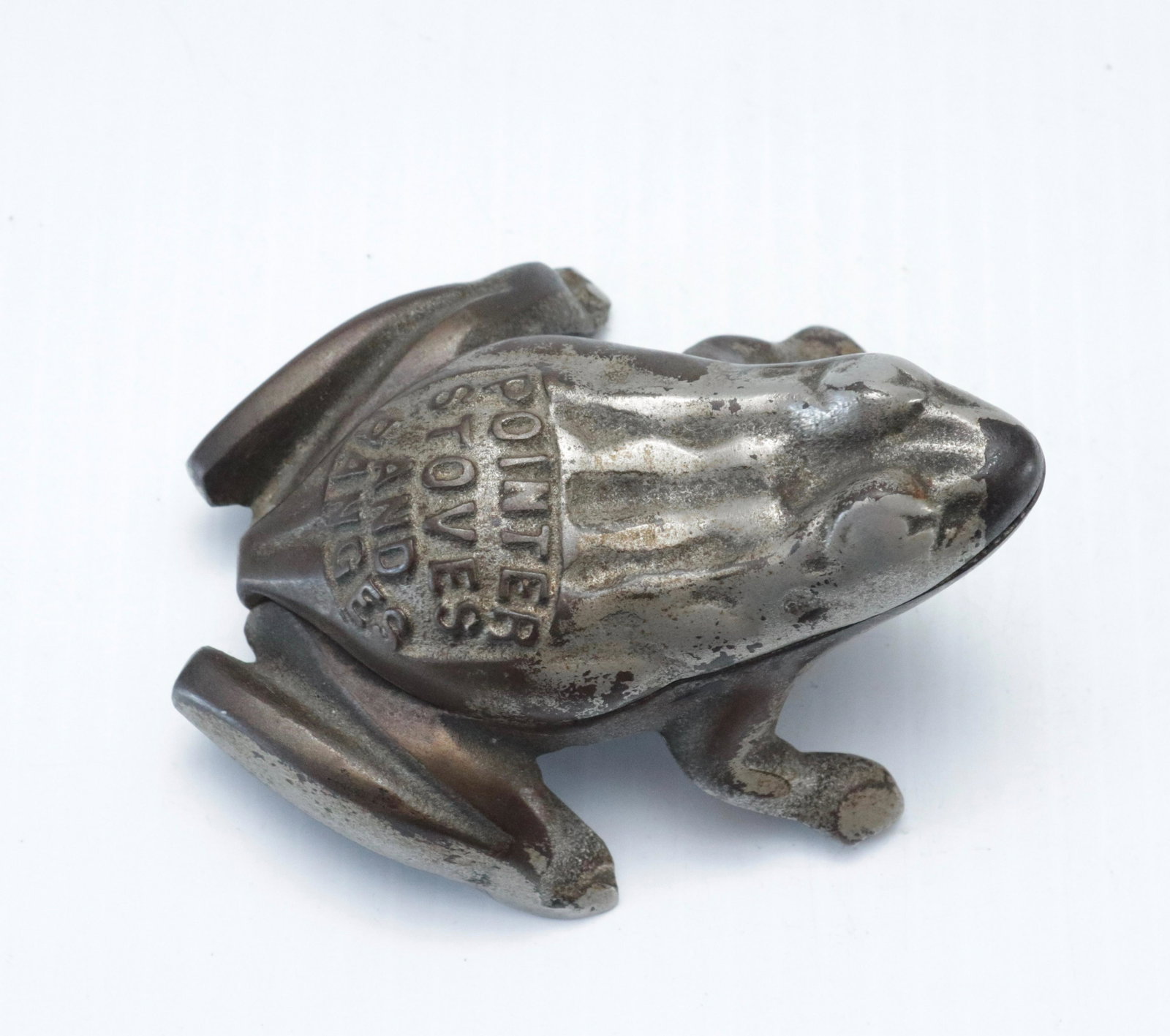 NICKELED CAST IRON ADVERTISING FROG MATCH HOLDER: POINTER STOVES AND RANGES" MADE BY; GOHMANN BROS. & KAHLER CO. NEW ALBANY, INDIANA 1 3/4" X 4