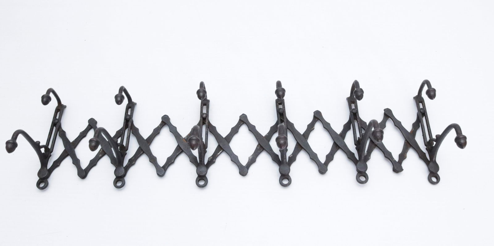 CAST IRON FOLDING COAT RACK: PAINTED SURFACE. ACORN FINIALS 26" X 4 3/4"