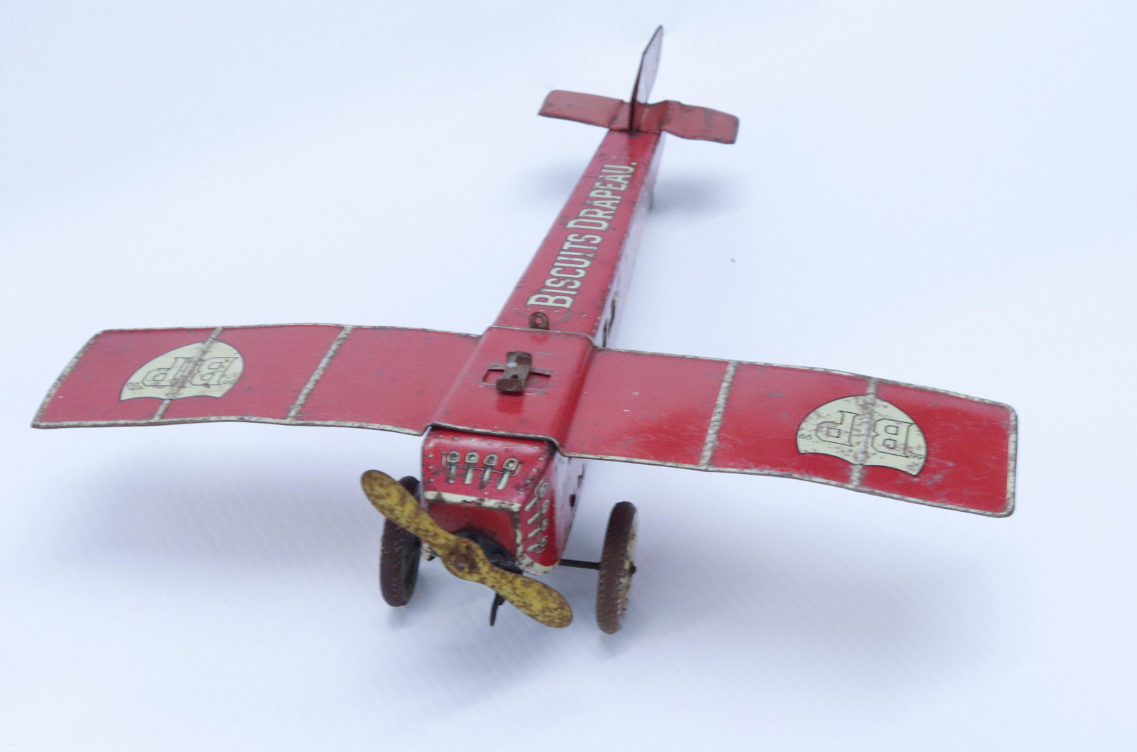 DRAPEA BISCUITS "BP": CIRCA 1930 - TIN LITHOGRAPH WITH WIND-UP MECHANISM PLANE - D.19 15 1/2" X 14 1/4"