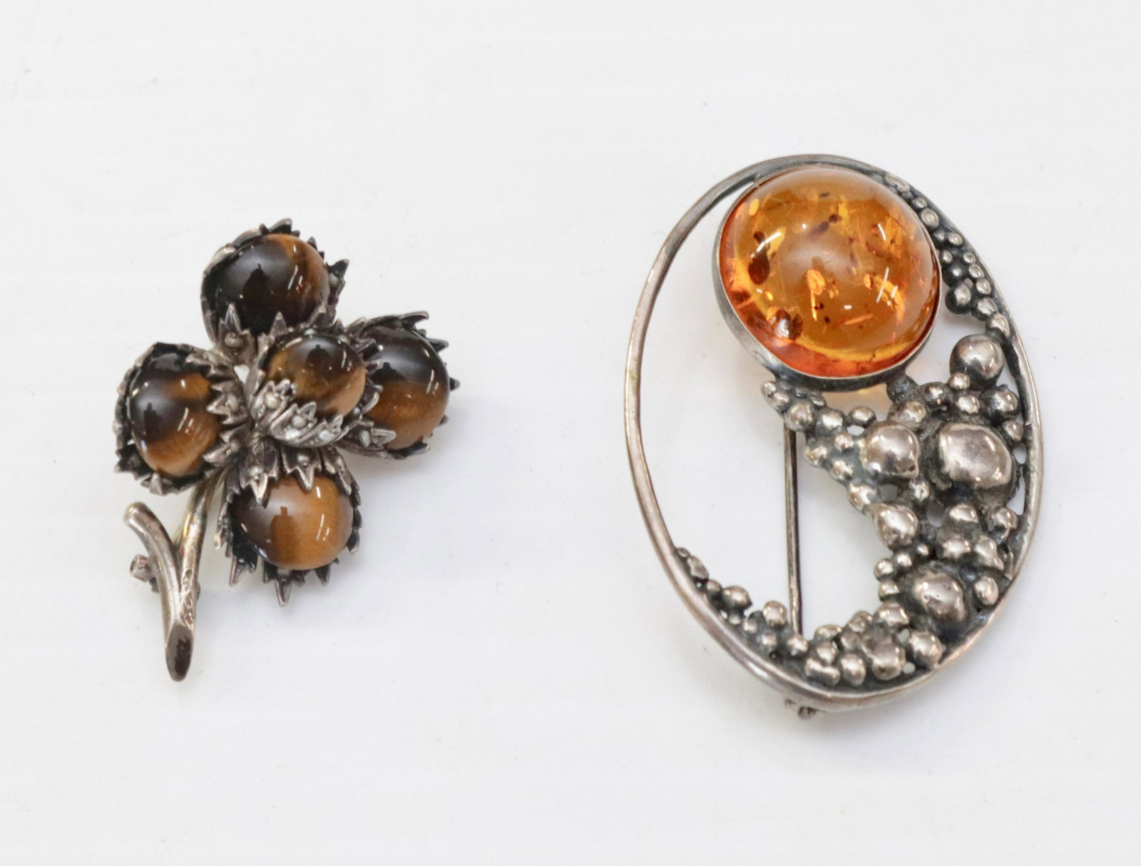(2) STERLING SILVER BROOCHeS: POLISHED SILVER AND AMBER (UNMARKED) - TIGERS EYE AND SEED PEARLS (UNMARKED) - .75 OZT 2" X 1 1/2" - 1" X 1"